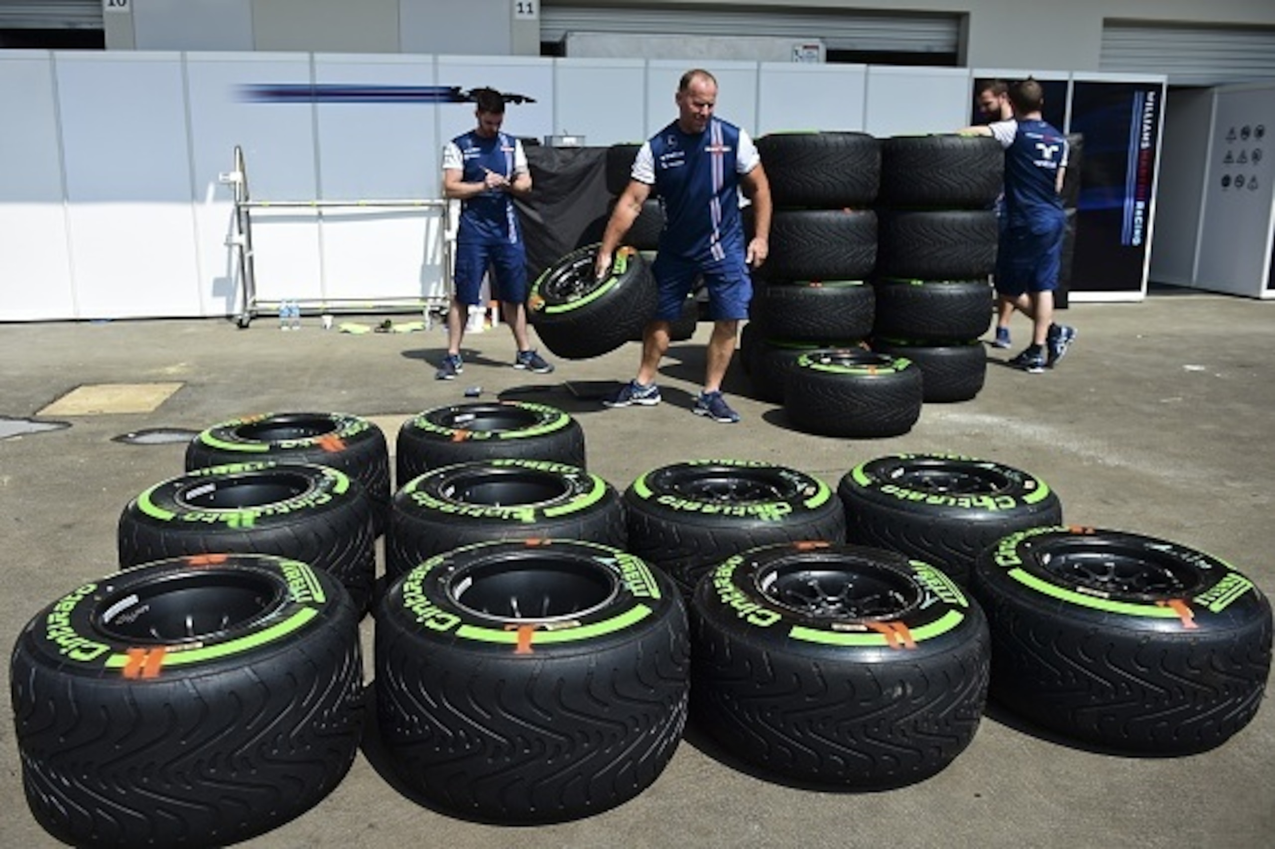 Members of Williams Martini Racing team work in the pits with tires at the Hermanos Rodriguez Racetrack on October 29, 2015. Mexico will hold its Formula 1 Grand Prix on November 1. AFP PHOTO/RONALDO SCHEMIDT        (Photo credit should read RONALDO SCHEM