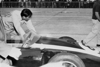 Jack Brabham pushes his car across the line at the 1959 U.S. Grand Prix.