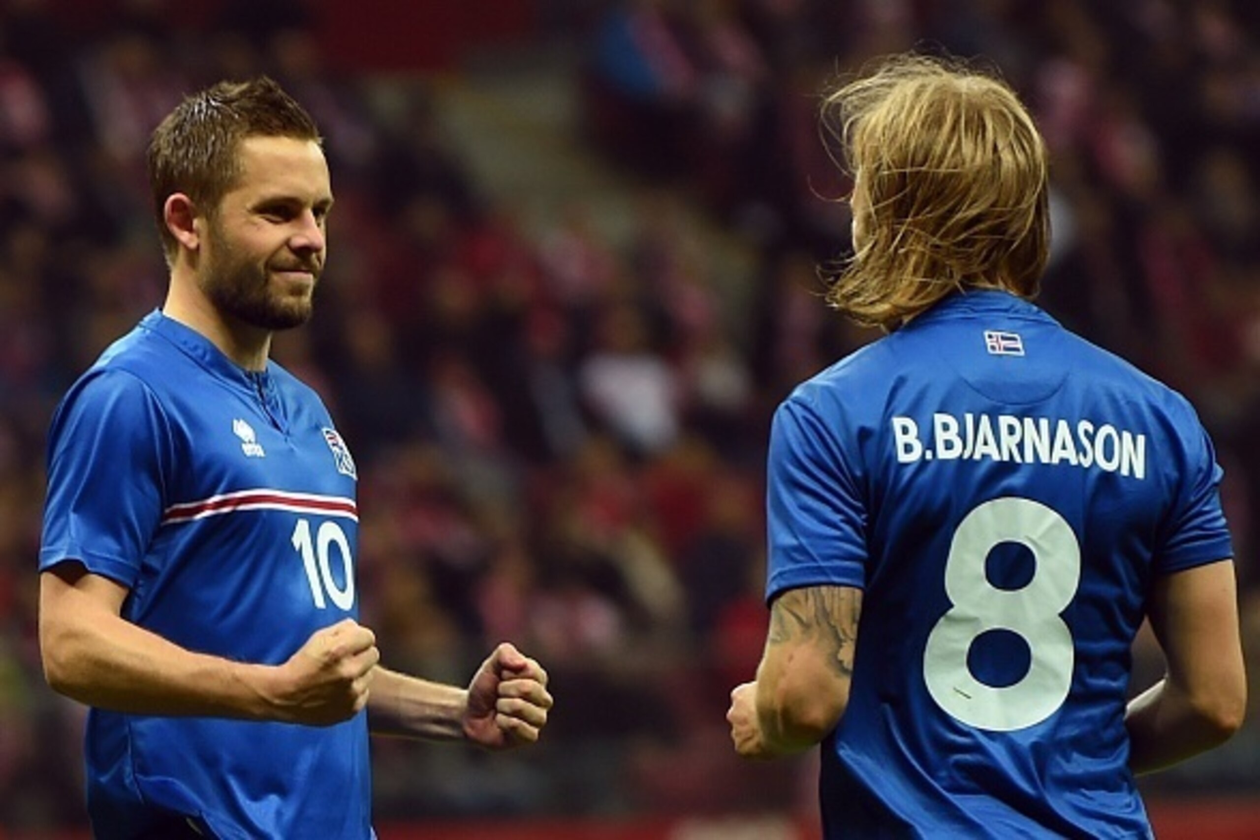 Iceland's Gylfi Sigurdsson and Birkir Bjarnason celebrate after Sigurdsson scored a penaly against Poland during the international friendly football match Poland vs Iceland on November 13, 2015 in Warsaw. AFP PHOTO/JANEK SKARZYNSKI        (Photo credit sh
