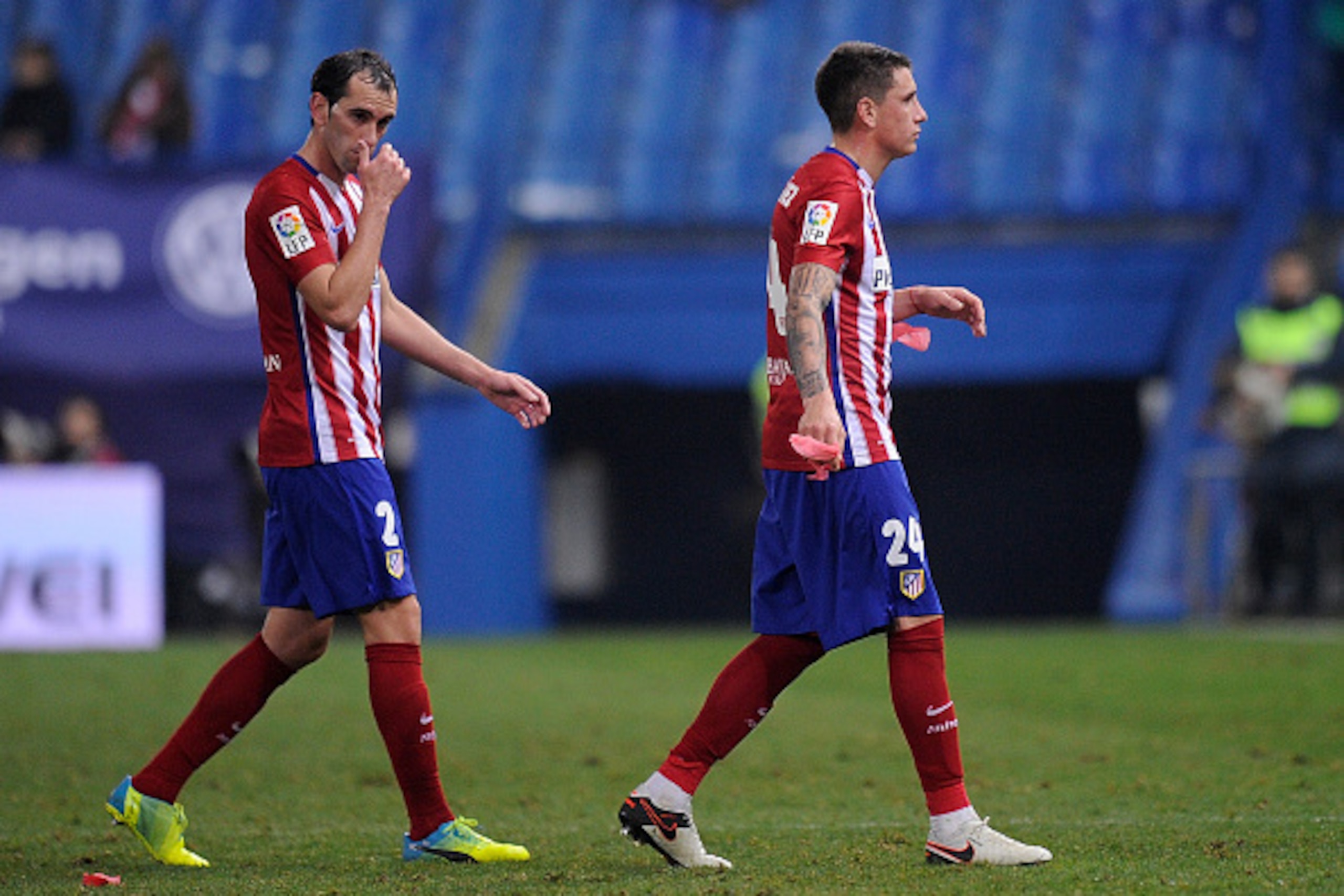 MADRID, SPAIN - JANUARY 27:  Jose Maria Gimenez (#24) and Diego Godin of Club Atletico de Madrid leave the pitch dejected after losing 3-2 to Celta Vigo in the Copa del Rey Quarter Final 2nd Leg match between Club Atletico de Madrid and Celta Vigo at Vice