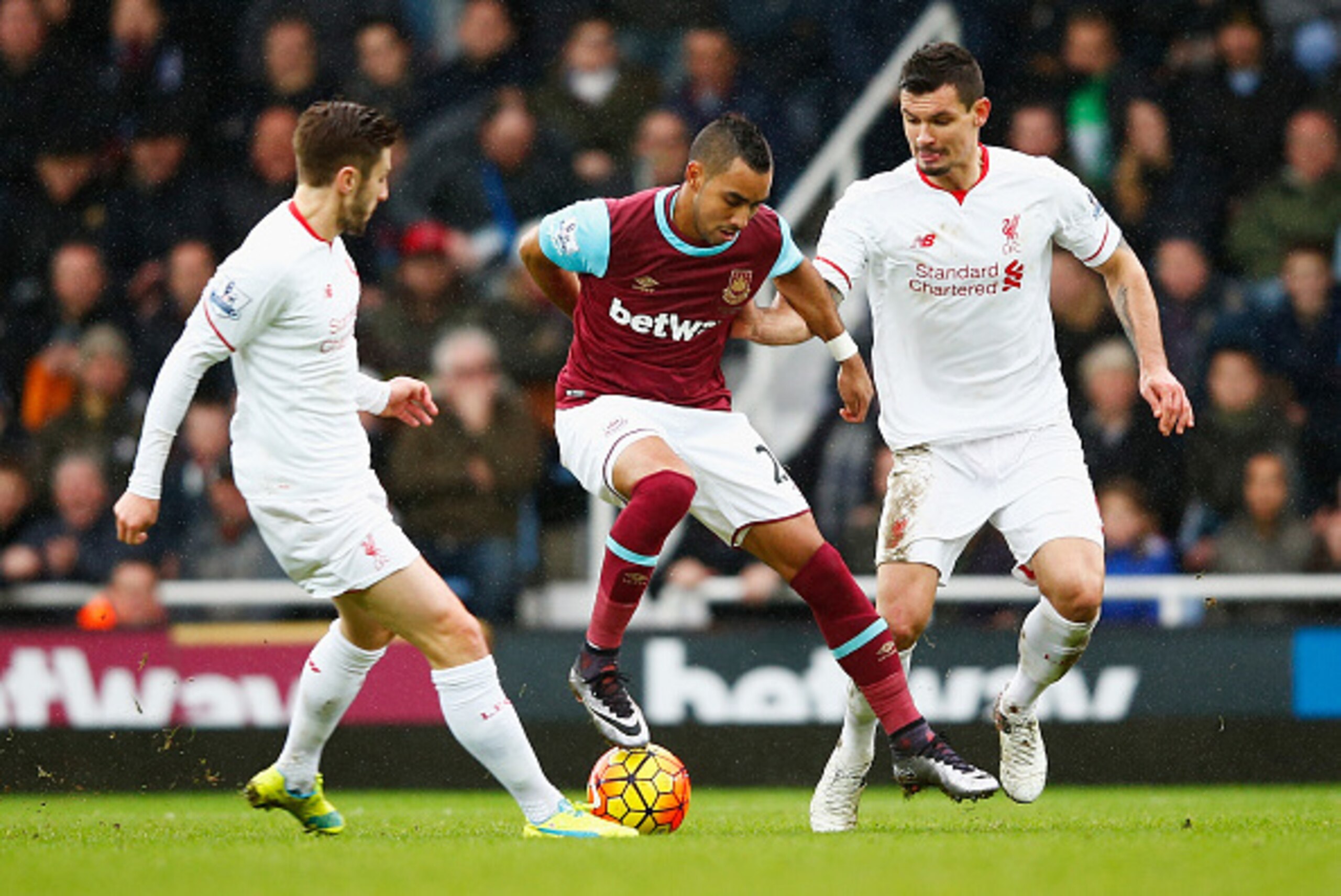 LONDON, ENGLAND - JANUARY 02: Dimitri Payet (C) of West Ham United competes for the ball against Adam Lallana (L) and Dejan Lovren (R) of Liverpool during the Barclays Premier League match between West Ham United and Liverpool at Boleyn Ground on January 