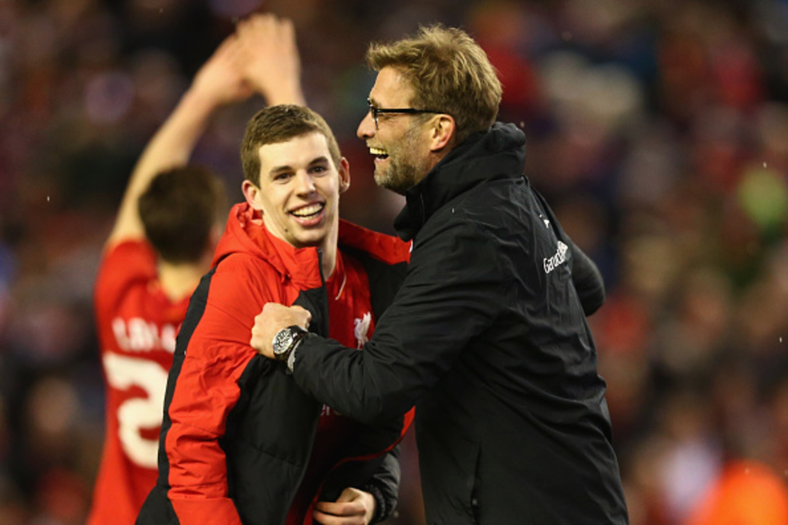 LIVERPOOL, ENGLAND - JANUARY 26:  Jurgen Klopp manager of Liverpool and Jon Flanagan of Liverpool celebrate victory in the penalty shoot out after the Capital One Cup semi final second leg match between Liverpool and Stoke City at Anfield on January 26, 2