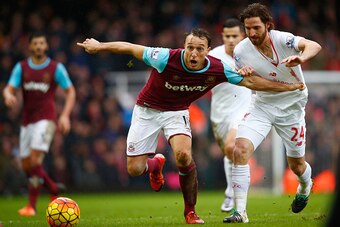 LONDON, ENGLAND - JANUARY 02:  Mark Noble of West Ham United and Joe Allen of Liverpool compete for the ball during the Barclays Premier League match between West Ham United and Liverpool at Boleyn Ground on January 2, 2016 in London, England.  (Photo by 