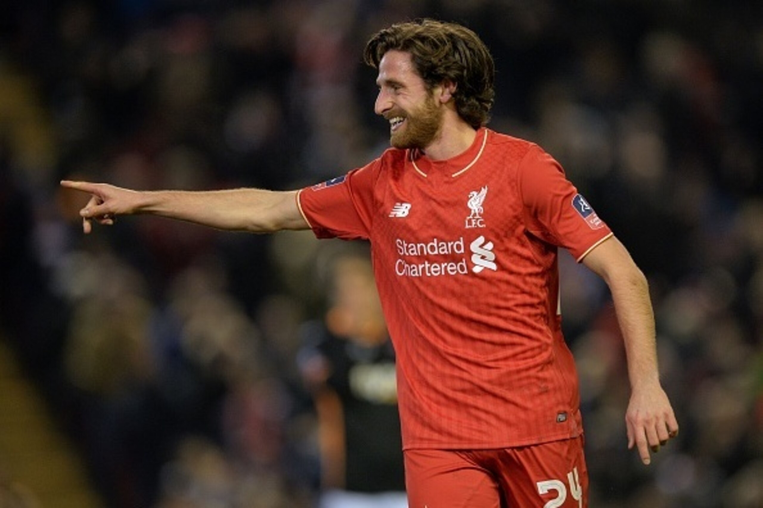 Liverpool's Welsh midfielder Joe Allen celebrates after scoring the opening goal of the English FA Cup third round replay football match between Liverpool and Exeter City at Anfield in Liverpool, north west England on January 20, 2016. AFP PHOTO / PAUL EL