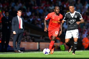 Liverpool's Nigerian midfielder Victor Moses (C) is challenged by Southampton's English defender Nathaniel Clyne (R) during the English Premier League football match between Liverpool and Southampton at Anfield stadium in Liverpool, northwest England, on