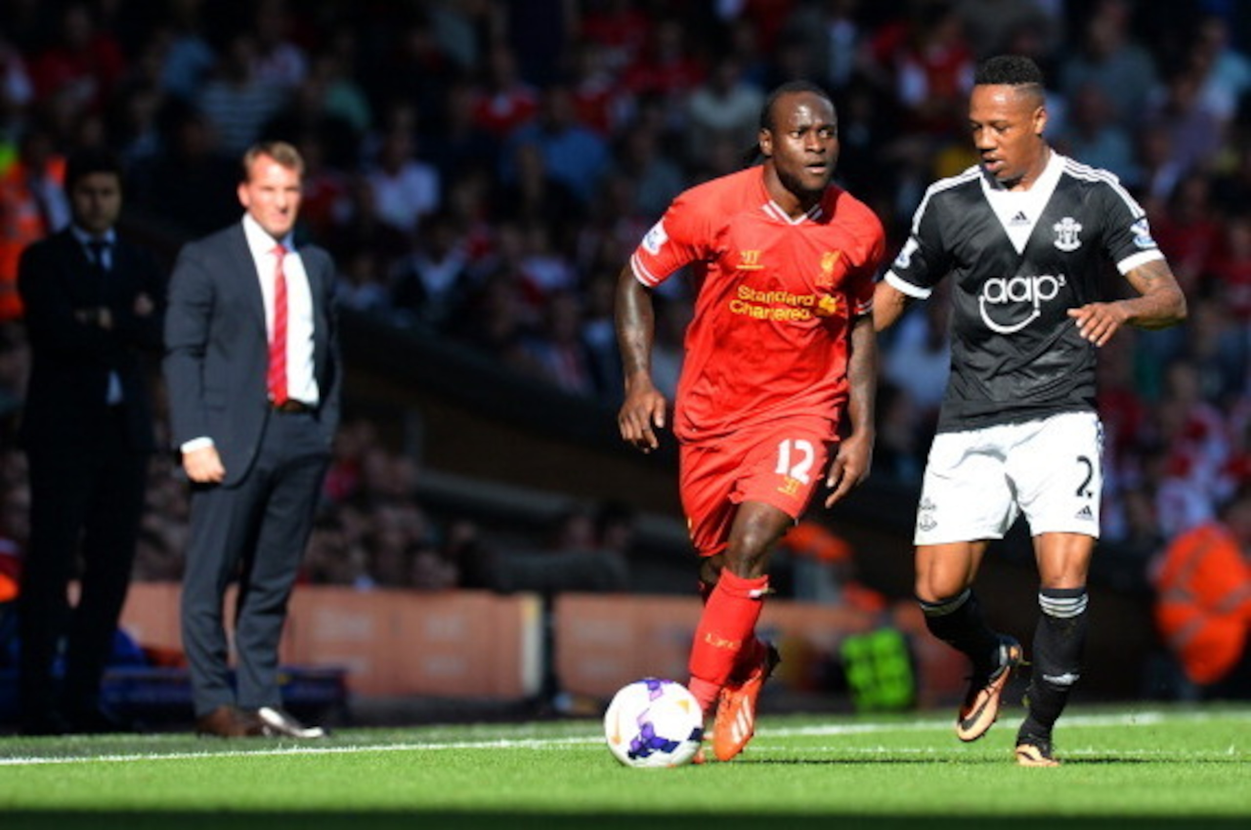 Liverpool's Nigerian midfielder Victor Moses (C) is challenged by Southampton's English defender Nathaniel Clyne (R) during the English Premier League football match between Liverpool and Southampton at Anfield stadium in Liverpool, northwest England, on