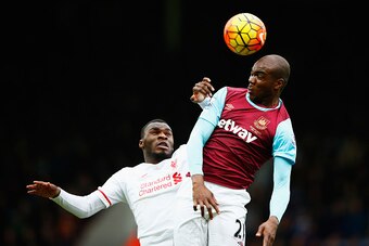 LONDON, ENGLAND - JANUARY 02: Angelo Ogbonna Obinza of West Ham United and Christian Benteke of Liverpool compete for the ball during the Barclays Premier League match between West Ham United and Liverpool at Boleyn Ground on January 2, 2016 in London, En