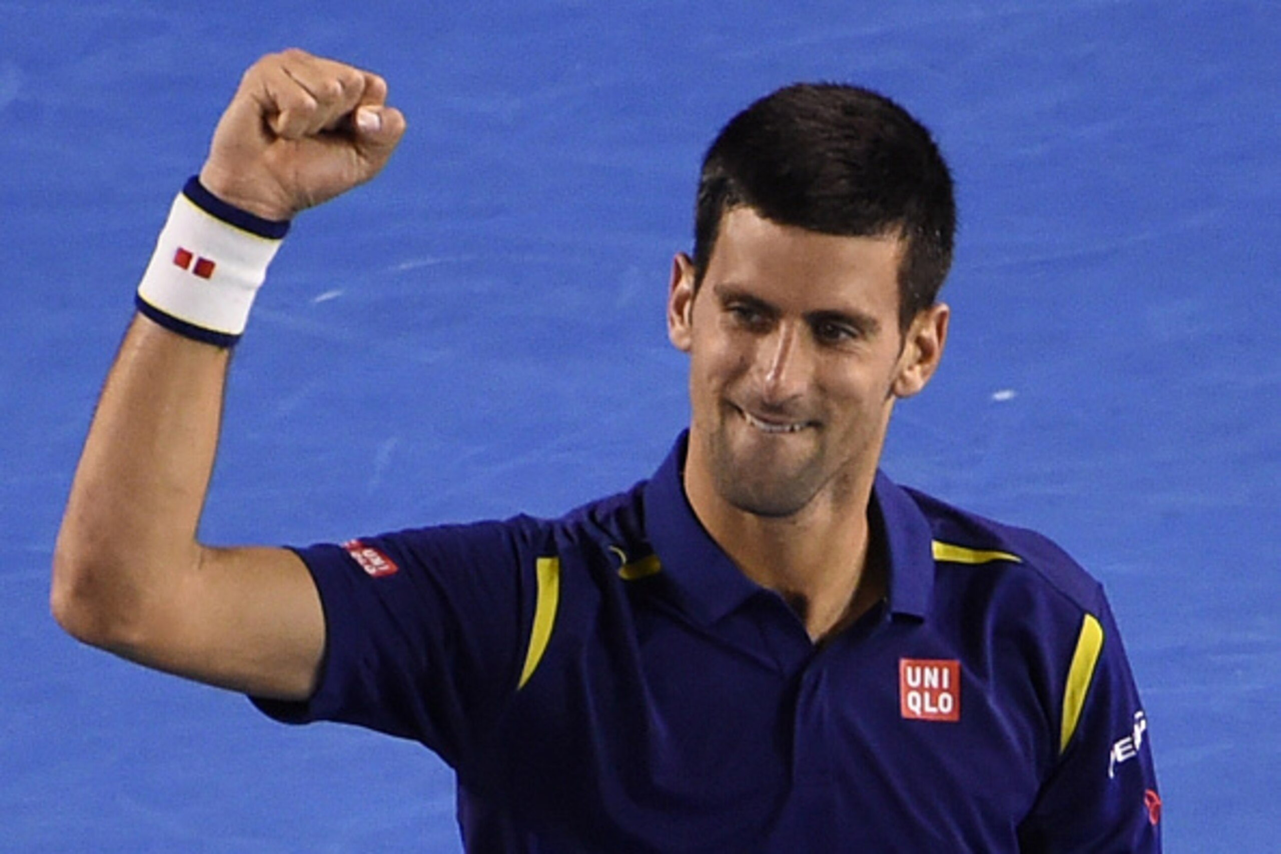Serbia's Novak Djokovic celebrates after victory in his men's singles semi-final match against Switzerland's Roger Federer on day eleven of the 2016 Australian Open tennis tournament in Melbourne on January 28, 2016. AFP PHOTO / WILLIAM WEST-- IMAGE RESTR