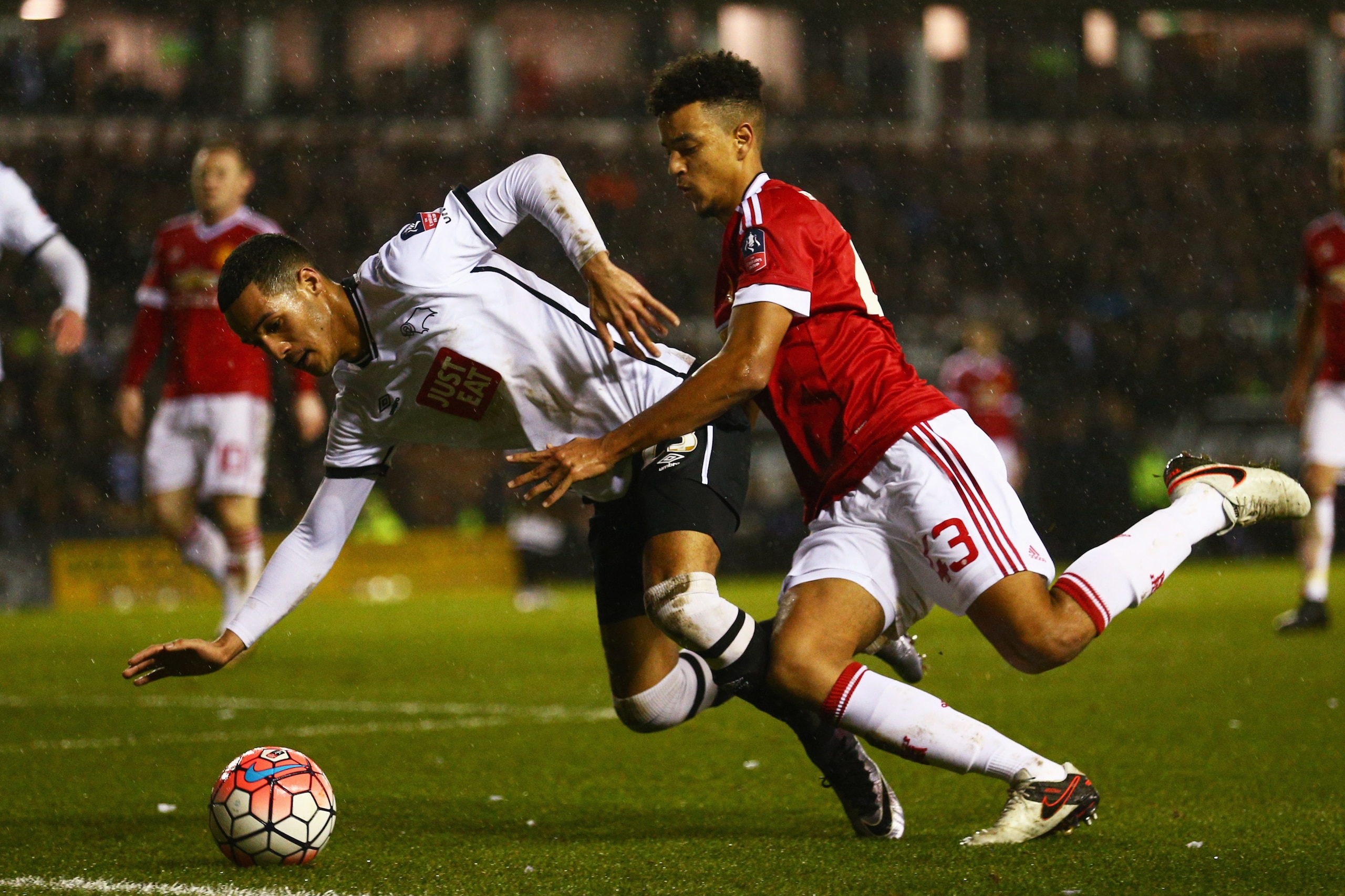 DERBY, ENGLAND - JANUARY 29: Tom Ince of Derby County battles with Cameron Borthwick-Jackson of Manchester United during the Emirates FA Cup fourth round match between Derby County and Manchester United at iPro Stadium on January 29, 2016 in Derby, Engla DERBY, ENGLAND - JANUARY 29: Tom Ince of Derby County battles with Cameron Borthwick-Jackson of Manchester United during the Emirates FA Cup fourth round match between Derby County and Manchester United at iPro Stadium on January 29, 2016 in Derby, Engla