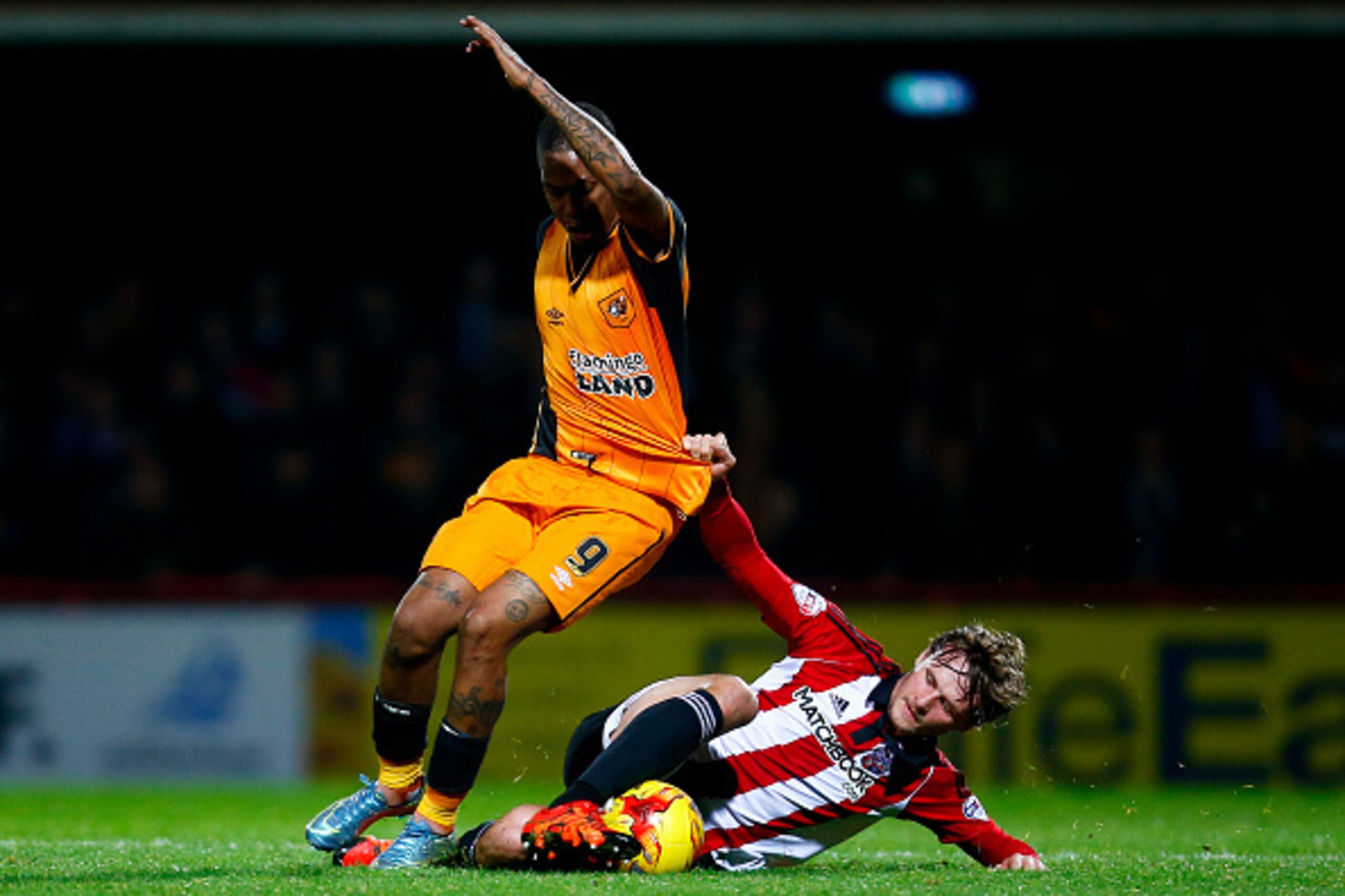 BRENTFORD, ENGLAND - NOVEMBER 03:  John Swift of Brentford pulls the shirt of Abel Hernandez of Hull during the Sky Bet Championship match between Brentford and Hull City on November 3, 2015 in Brentford, United Kingdom.  (Photo by Jordan Mansfield/Getty 