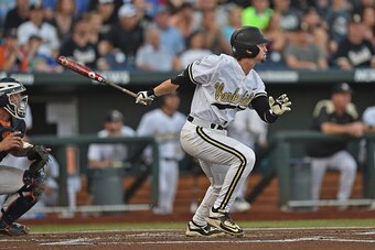 OMAHA, NE - JUNE 24  Right fielder Rhett Wiseman #8 of the Vanderbilt Commodores doubles against the Virginia Cavaliers in the first inning during game three of the College World Series Championship Series on June 24, 2015 at TD Ameritrade Park in Omaha, 
