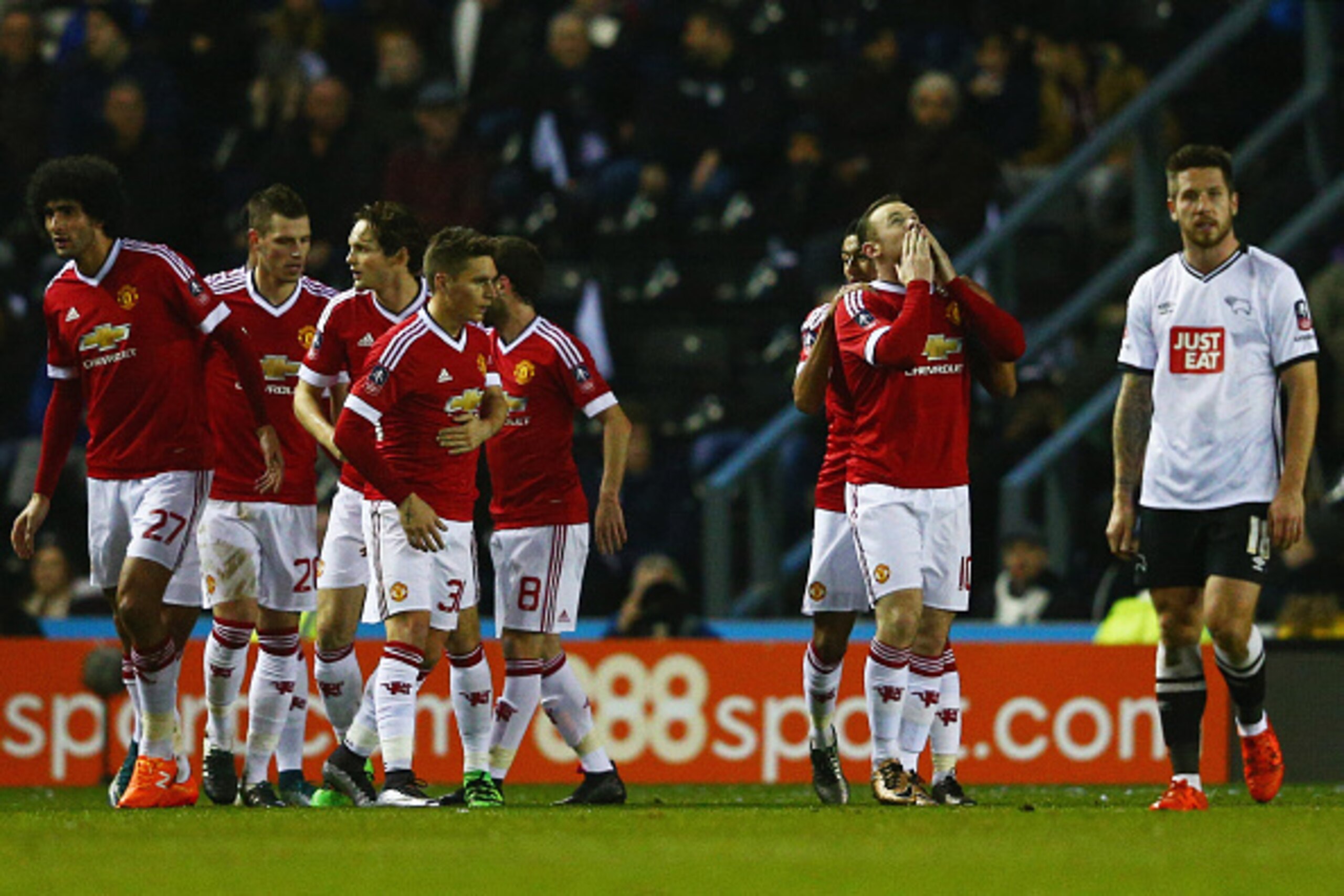 DERBY, ENGLAND - JANUARY 29:  Jacob Butterfield of Derby County (R) looks dejected as Wayne Rooney of Manchester United (10) celebrates with team mates as he scores ther first goal during the Emirates FA Cup fourth round match between Derby County and Man