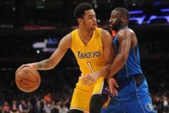 January 26, 2016; Los Angeles, CA, USA; Los Angeles Lakers guard D'Angelo Russell (1) moves the ball against Dallas Mavericks guard Wesley Matthews (23) during the second half at Staples Center. Mandatory Credit: Gary A. Vasquez-USA TODAY Sports
