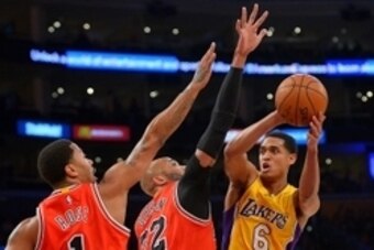 Jan 28, 2016; Los Angeles, CA, USA; Chicago Bulls guard Derrick Rose (1) and Chicago Bulls forward Taj Gibson (22) defend a shot by Los Angeles Lakers guard Jordan Clarkson (6) in the first half of the game at Staples Center. Mandatory Credit: Jayne Kamin
