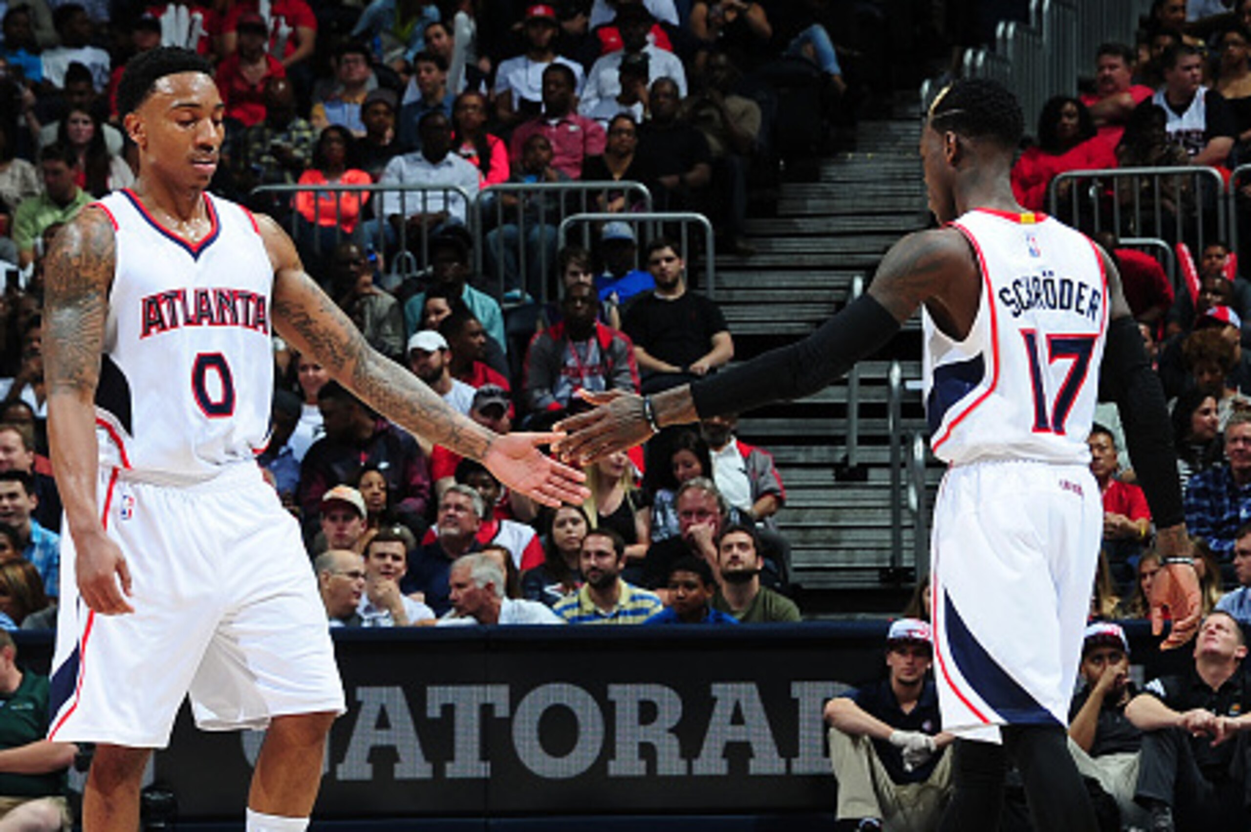 ATLANTA, GA - APRIL 7:  Jeff Teague #0 and Dennis Schroder #17 of the Atlanta Hawks shake hands during the game against the Phoenix Suns on April 7, 2015 at Philips Arena in Atlanta, Georgia.  NOTE TO USER: User expressly acknowledges and agrees that, by