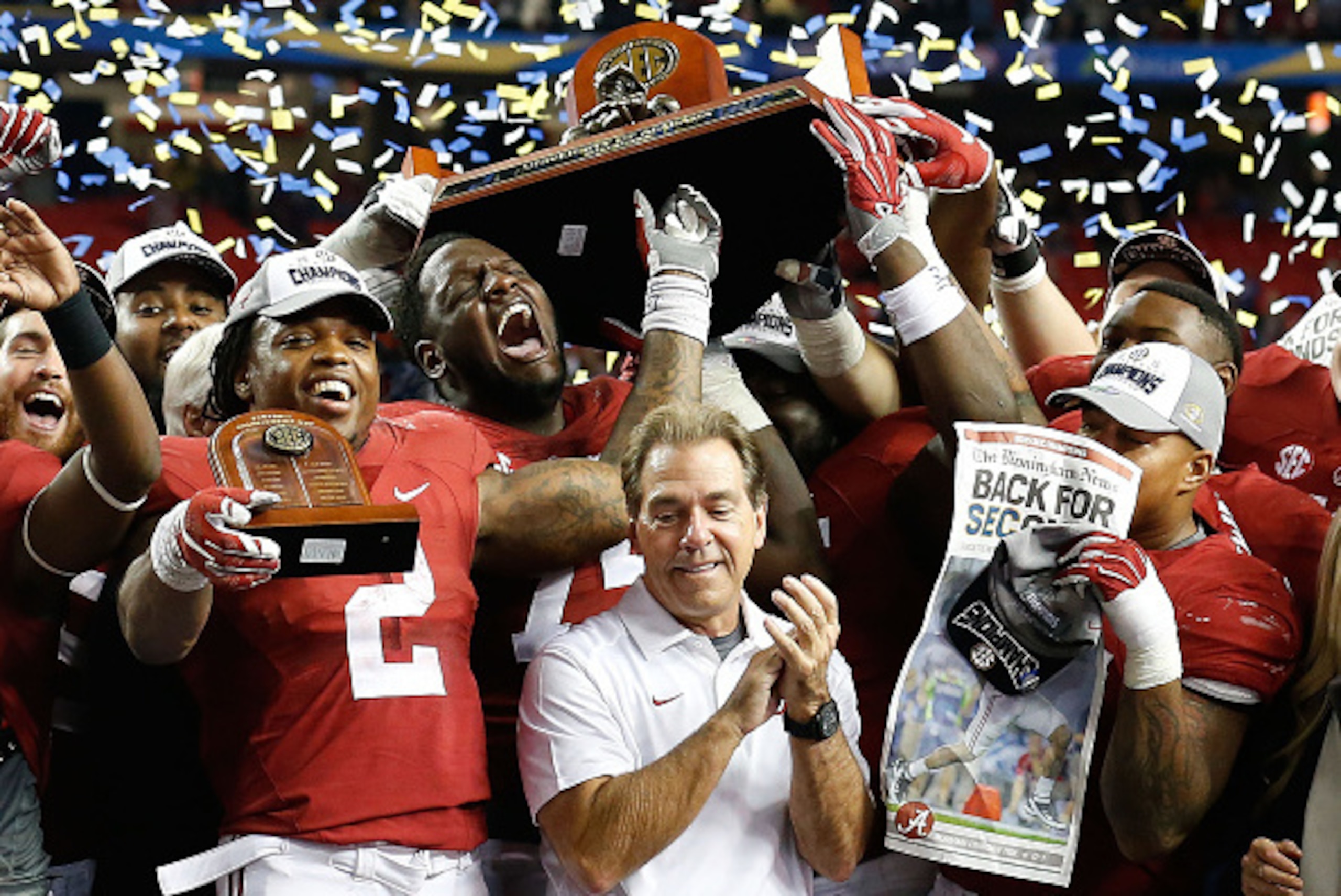 ATLANTA, GA - DECEMBER 05:  Members of the Alabama Crimson Tide, including running back Derrick Henry #2 (front, left) and head coach Nick Saban (center) celebrate after the SEC Championship game against the Florida Gators at Georgia Dome on December 5, 2