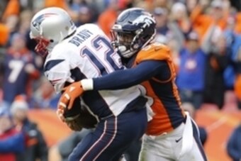 Jan 24, 2016; Denver, CO, USA; New England Patriots quarterback Tom Brady (12) is tackled by Denver Broncos outside linebacker Von Miller (58) in the third quarter in the AFC Championship football game at Sports Authority Field at Mile High. Mandatory Cre