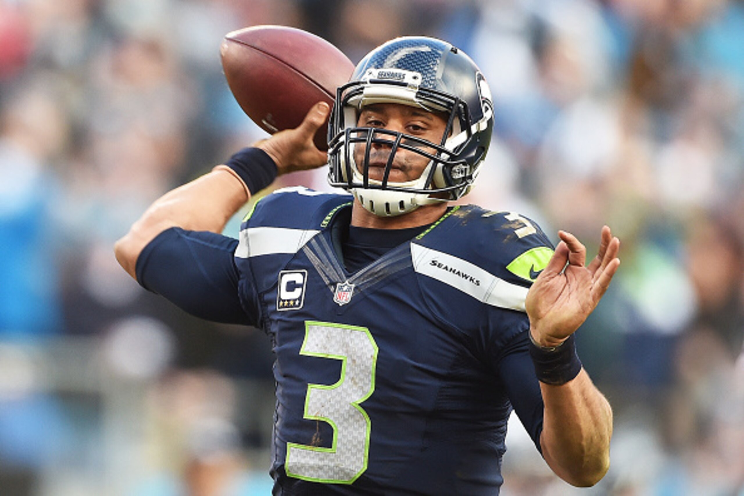 CHARLOTTE, NC - JANUARY 17:  Quarterback Russell Wilson #3 of the Seattle Seahawks passes during the NFC Divisional Playoff Game against the Carolina Panthers at Bank of America Stadium on January 17, 2016 in Charlotte, North Carolina.  (Photo by Ronald C