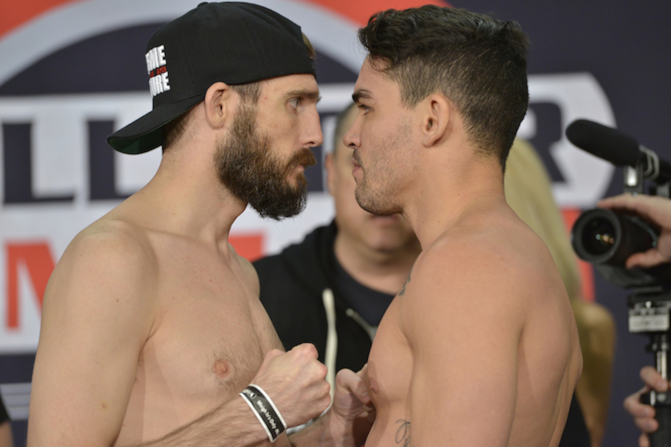 Couture and Pitbull get up close and personal at Thursday's weigh-in.