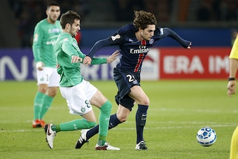PARIS, FRANCE - DECEMBER 16: Adrien Rabiot of PSG and Benjamin Corgnet of Saint-Etienne (left) in action during the French League Cup (Coupe de la Ligue) match between Paris Saint-Germain (PSG) and AS Saint-Etienne (ASSE) at Parc des Princes stadium on De