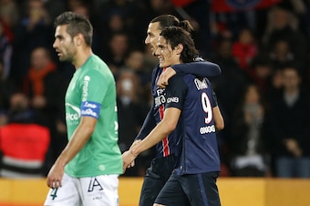PARIS, FRANCE - OCTOBER 25: Zlatan Ibrahimovic of PSG celebrates scoring the 3rd goal for his team with teammate Edinson Cavani as Loic Perrin of Saint-Etienne (L) looks dejected during the French Ligue 1 match between Paris Saint-Germain (PSG) and AS Sai