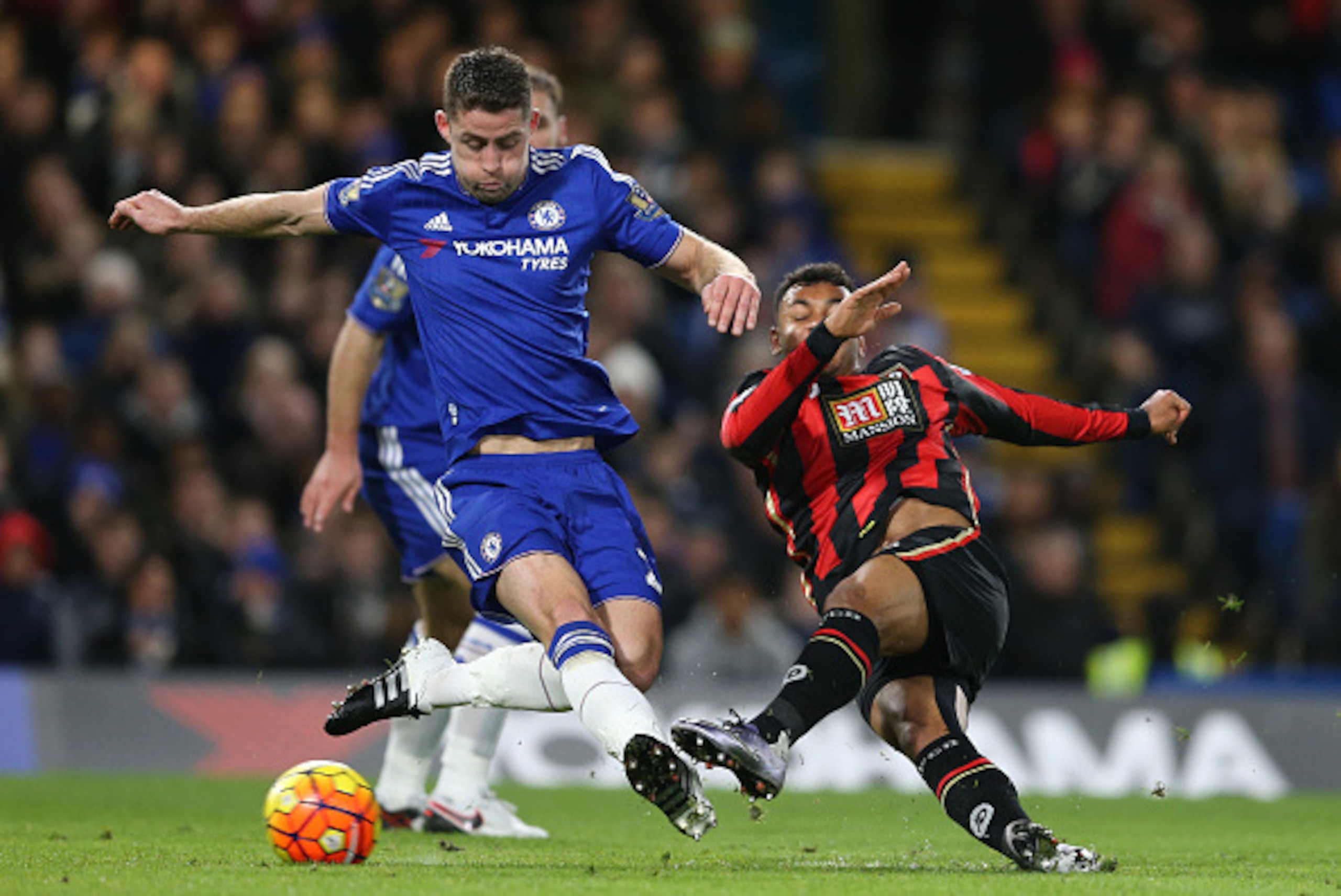 Bournemouth's Norwegian striker Joshua King (R) shoots past Chelsea's English defender Gary Cahill during the English Premier League football match between Chelsea and Bournemouth at Stamford Bridge in London on December 5, 2015.   AFP PHOTO / JUSTIN TALL