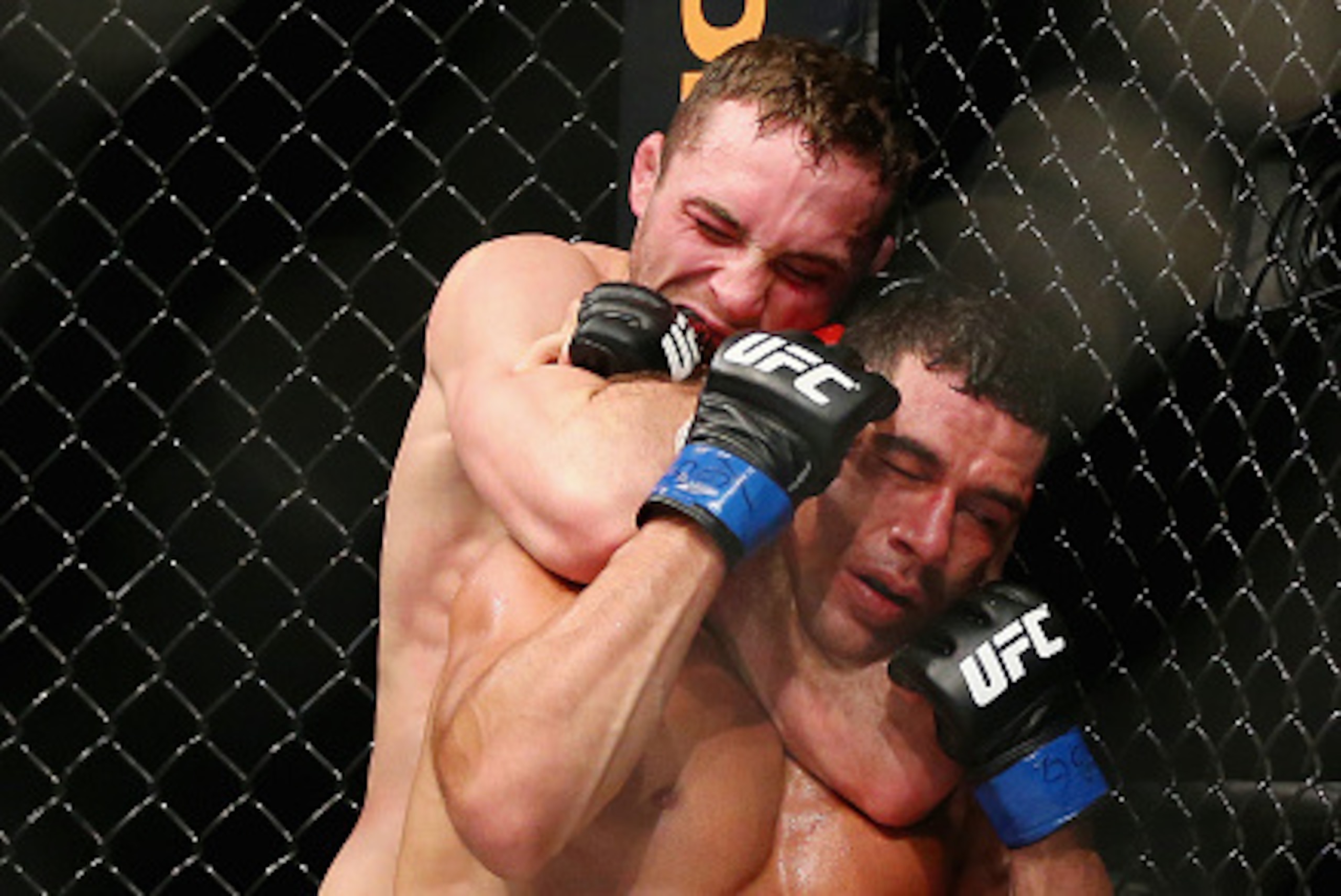 NEWARK, NJ - JANUARY 30:  Tony Martin of the United States performs a rear-naked choke in the third round to submit Felipe Olivieri of Brazil in their lightweight bout during the UFC Fight Night event at the Prudential Center on January 30, 2016 in Newark
