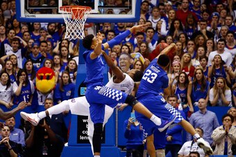 LAWRENCE, KS - JANUARY 30:  Skal Labissiere #1 and Jamal Murray #23 of the Kentucky Wildcats foul Wayne Selden Jr. #1 of the Kansas Jayhawks during overtime in the game at Allen Fieldhouse on January 30, 2016 in Lawrence, Kansas.  (Photo by Jamie Squire/G