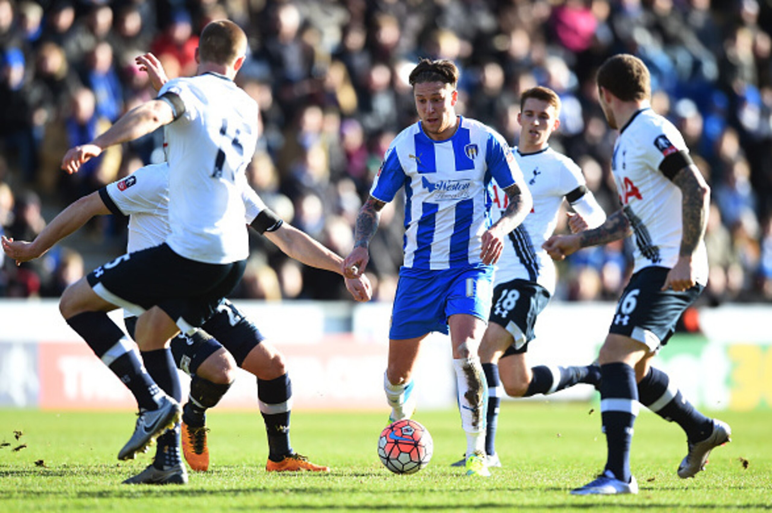 COLCHESTER, ENGLAND - JANUARY 30: George Moncur of Colchester United controls the ball under pressure of Tottenham Hotspur defense during the Emirates FA Cup Fourth Round match between Colchester United and Tottenham Hotspur at Weston Homes Community Stad