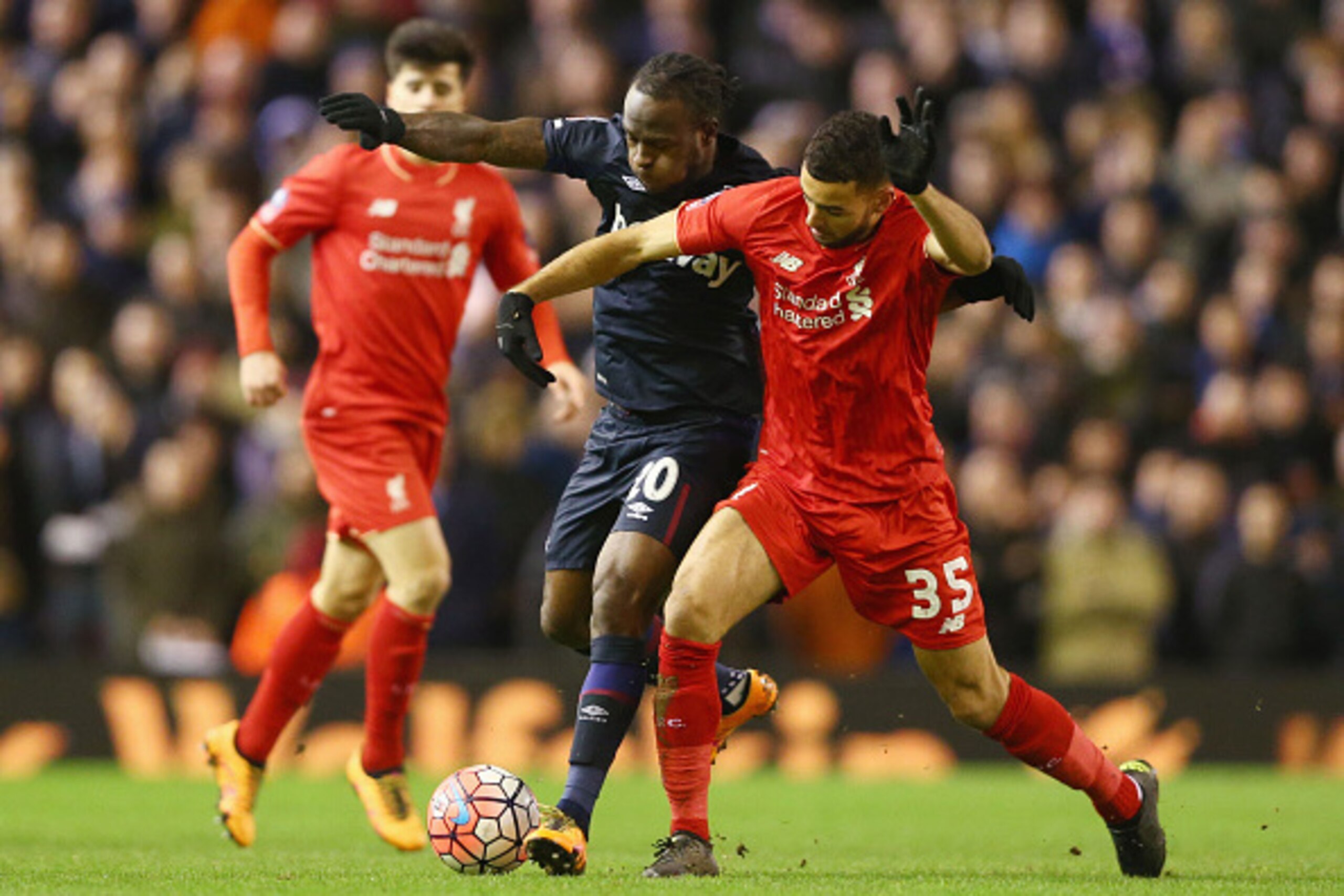 LIVERPOOL, ENGLAND - JANUARY 30: Kevin Stewart of Liverpool and Victor Moses of West Ham United compete for the ball during the Emirates FA Cup Fourth Round match between Liverpool and West Ham United at Anfield on January 30, 2016 in Liverpool, England. 