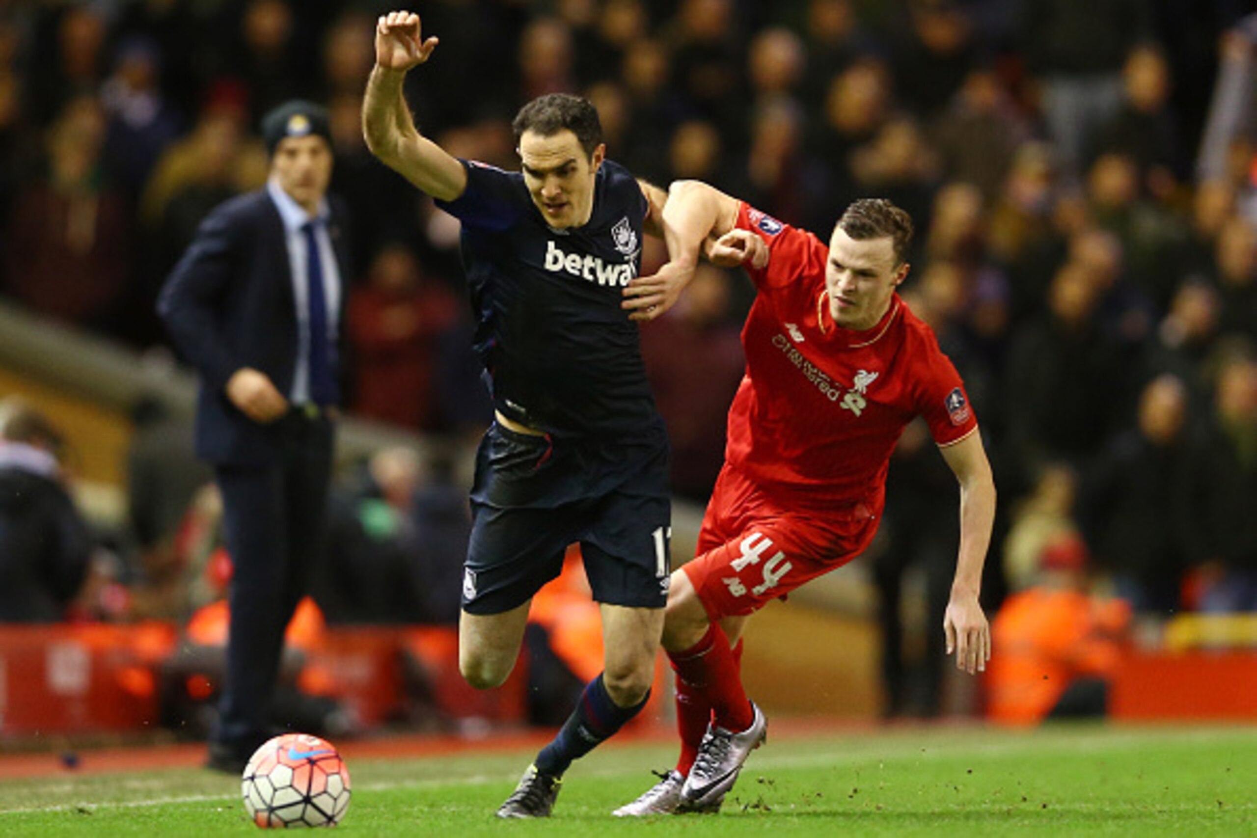 LIVERPOOL, ENGLAND - JANUARY 30:  Joey O'Brien of West Ham United holds off Joe Allen of Liverpool during the Emirates FA Cup Fourth Round match between Liverpool and West Ham United at Anfield on January 30, 2016 in Liverpool, England.  (Photo by Clive B