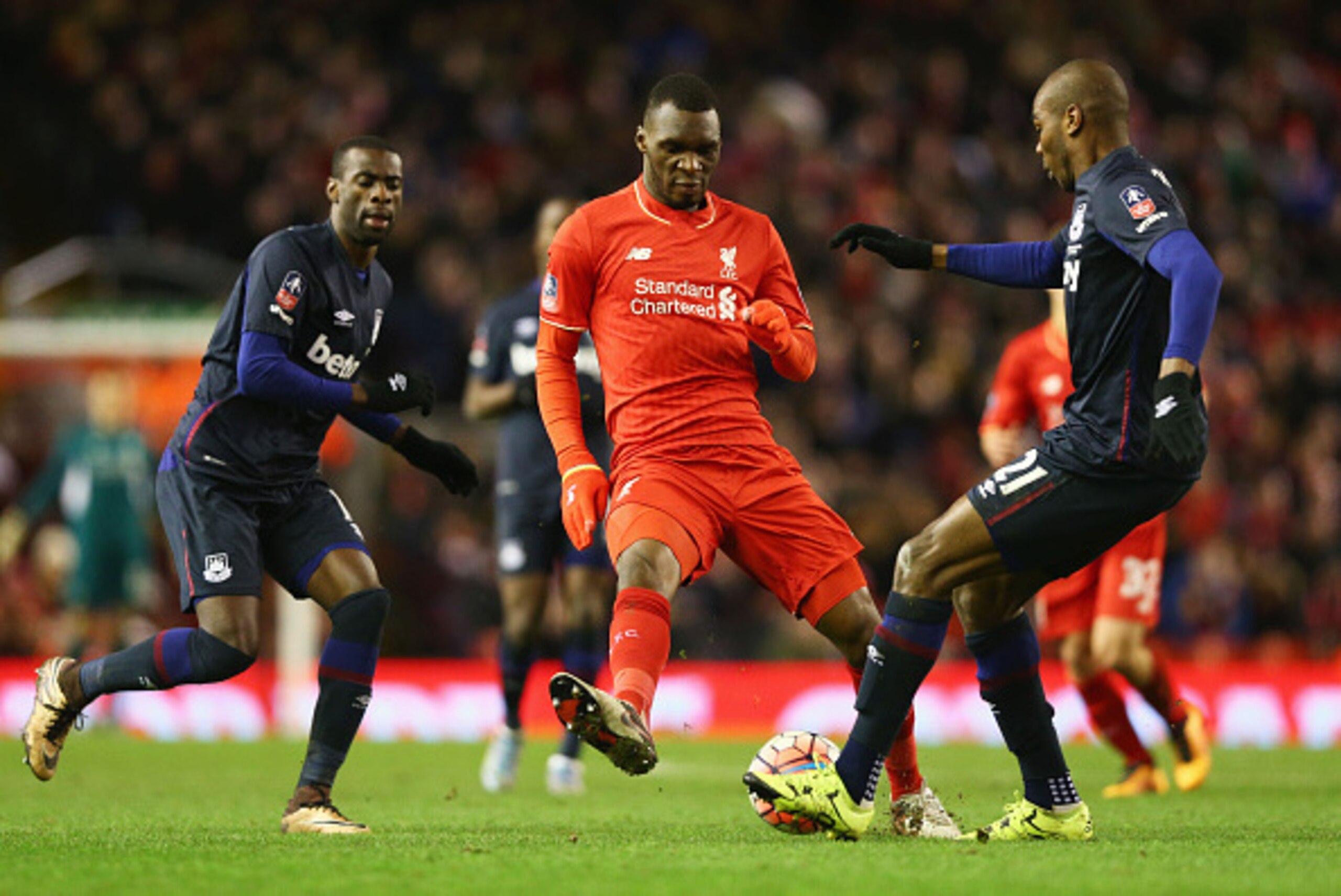 LIVERPOOL, ENGLAND - JANUARY 30:  Christian Benteke of Liverpool is foiled by Angelo Ogbonna Obinza (R) and Pedro Mba Obiang of West Ham United (L) during the Emirates FA Cup Fourth Round match between Liverpool and West Ham United at Anfield on January 3