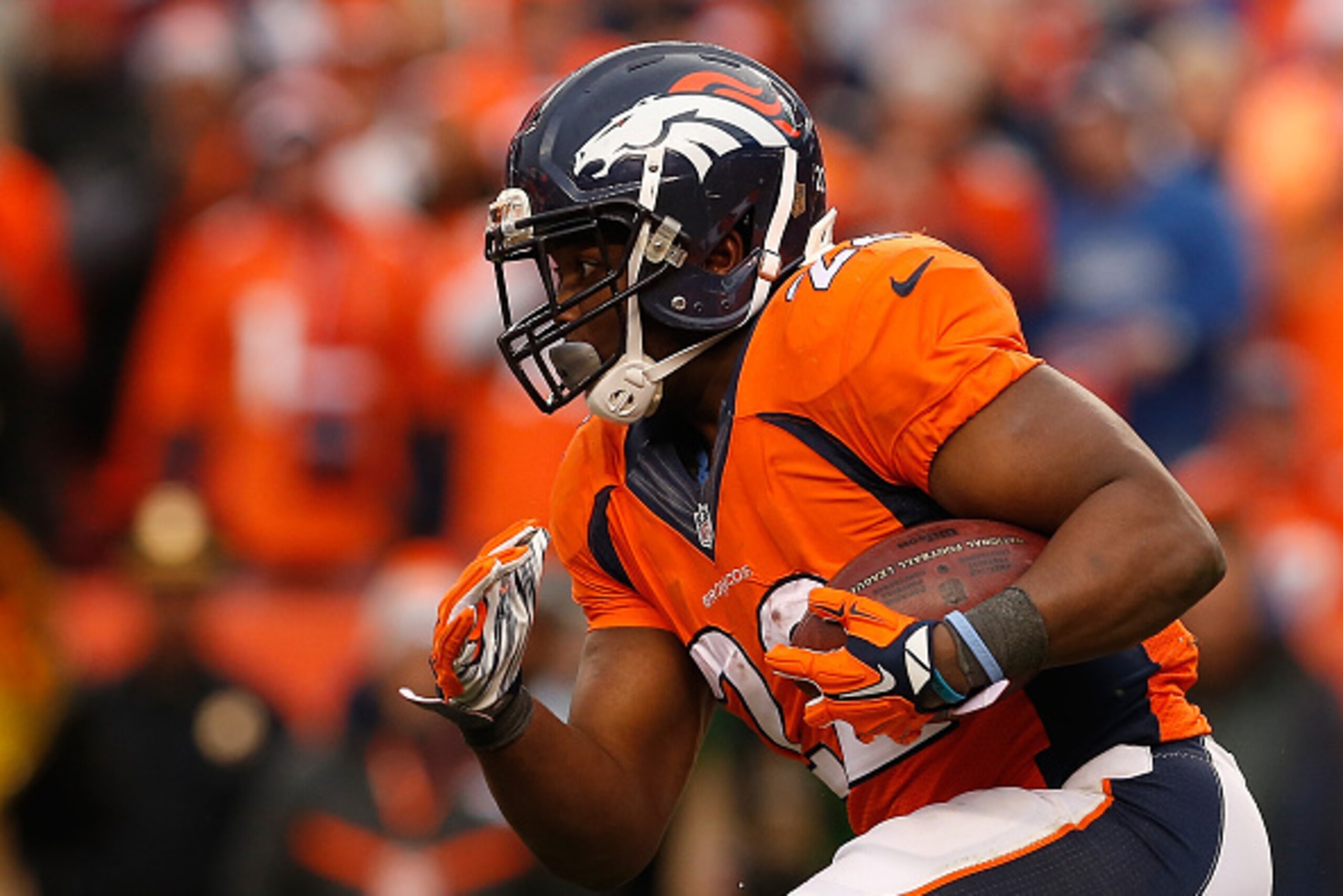 DENVER, CO - JANUARY 24:  Running back C.J. Anderson #22 of the Denver Broncos rushes the football against the New England Patriots during the AFC Championship game at Sports Authority Field at Mile High on January 24, 2016 in Denver, Colorado. The Bronco