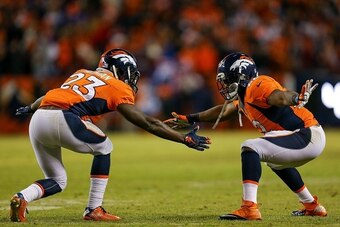DENVER, CO - JANUARY 3:  Denver Broncos running backs Ronnie Hillman #23 and C.J. Anderson #22 celebrate after a fourth quarter Hillman touchdown at Sports Authority Field at Mile High on January 3, 2016 in Denver, Colorado. (Photo by Justin Edmonds/Getty