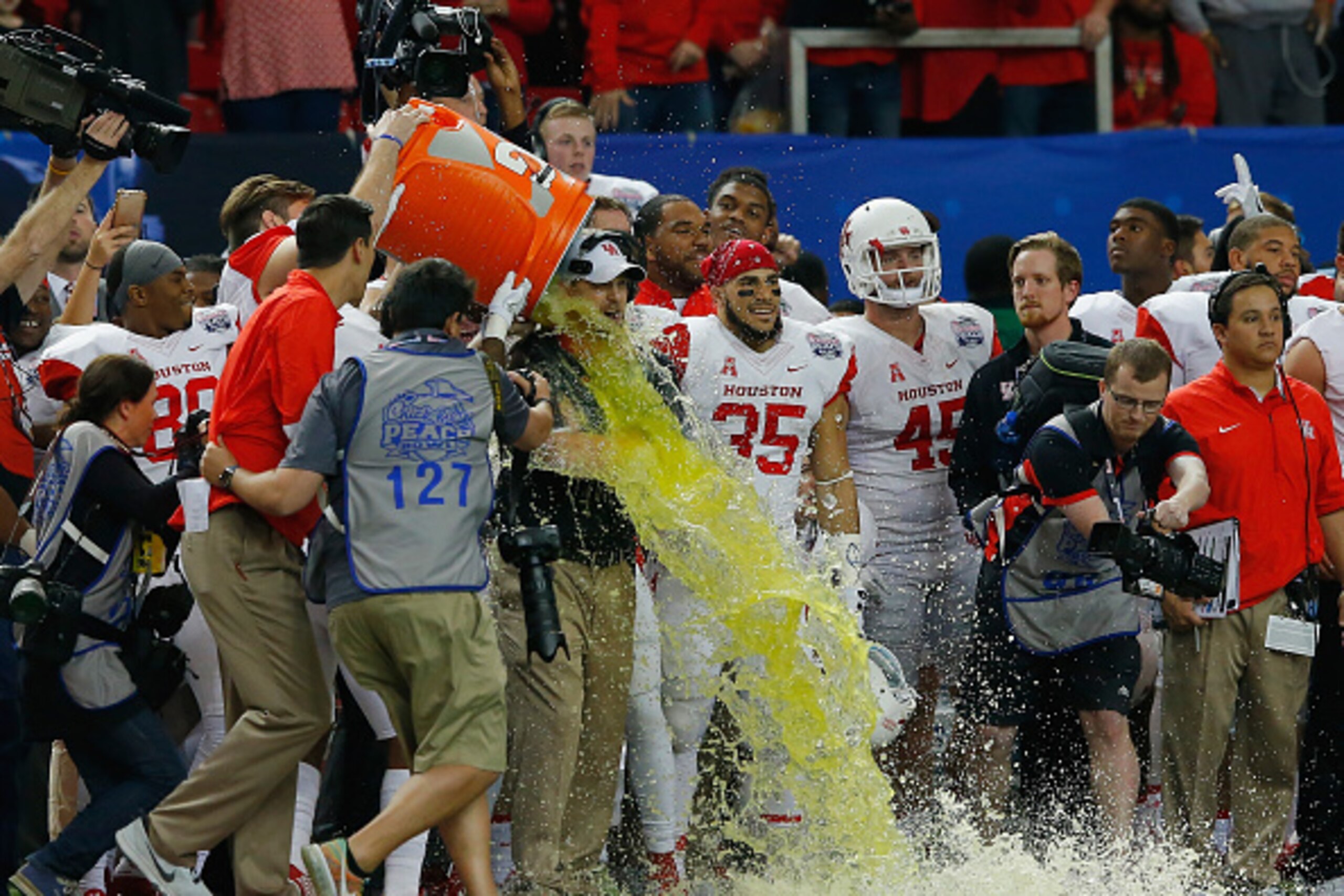 ATLANTA, GA - DECEMBER 31:  Head coach Tom Herman of the Houston Cougars  has Gatorade dumped on him in honor of their 38-24 win over the Florida State Seminoles during the Chick-fil-A Peach Bowl at the Georgia Dome on December 31, 2015 in Atlanta, Georgi