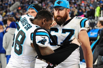CHARLOTTE, NC - JANUARY 24: Thomas Davis #58 of the Carolina Panthers sheds his sling for his broken arm while chatting with Ryan Kalil #67 against the Arizona Cardinals during the NFC Championship Game at Bank Of America Stadium on January 24, 2016 in Ch