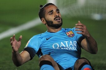 Barcelona's Brazilian defender Douglas sits on the field during the Spanish Copa del Rey (King's Cup) Round of 32 first leg football match CF Villanovense vs FC Barcelona at the Romero Cuerda stadium in Villanueva de la Serena on October 28, 2015. AFP PHO