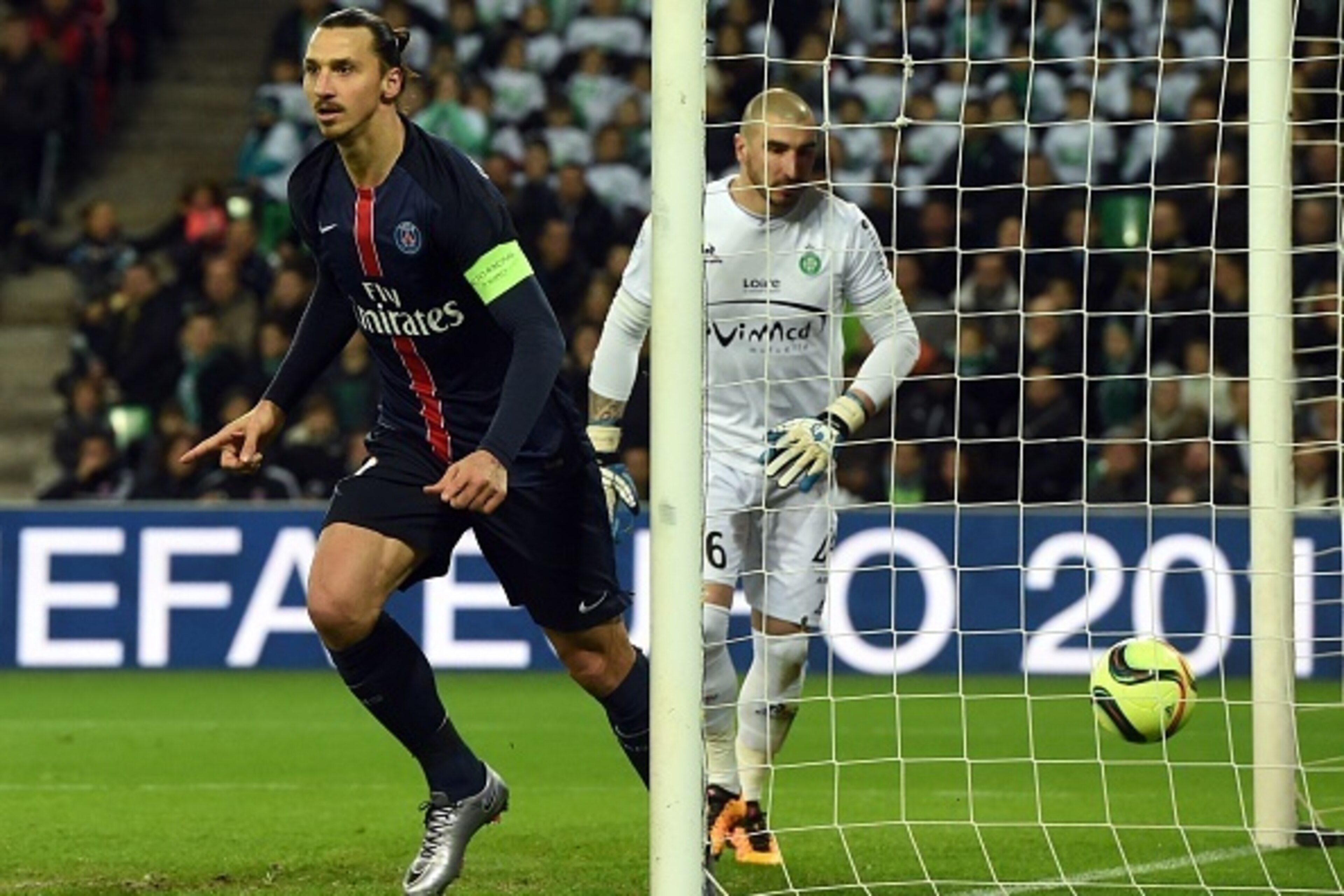 Paris Saint-Germain's Swedish forward Zlatan Ibrahimovic (L) celebrates next to Saint-Etienne's French goalkeeper Stephane Ruffier after scoring a goal during the Ligue1 football match between AS Saint-Etienne and Paris Saint-Germain, on January 31, 2016