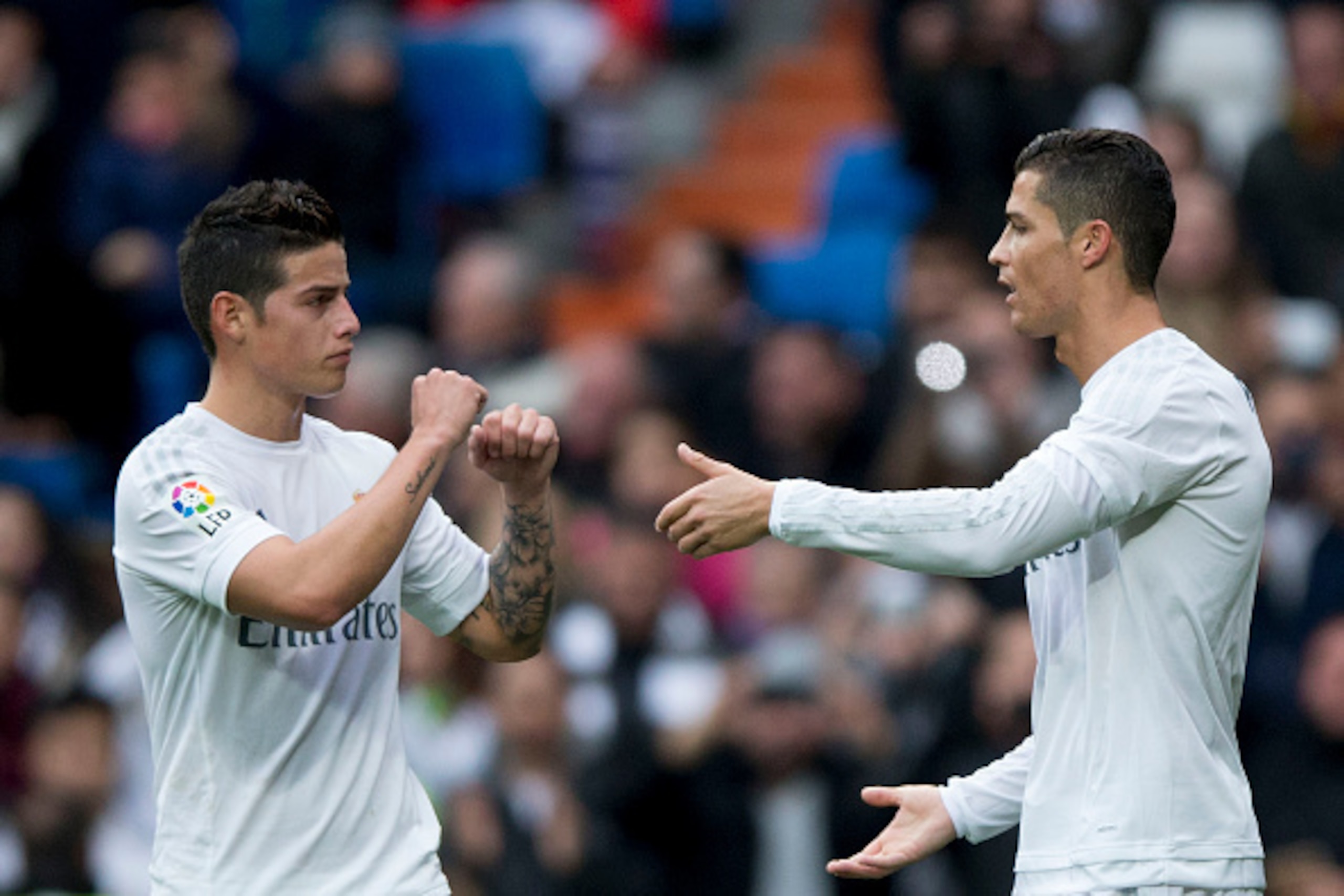 MADRID, SPAIN - DECEMBER 30:  Cristiano Ronaldo (R) of Real Madrid CF celebrates scoring their opening goal with teammate James Rodriguez (L) during the La Liga match between Real Madrid CF and Real Sociedad de Futbol at Estadio Santiago Bernabeu on Decem