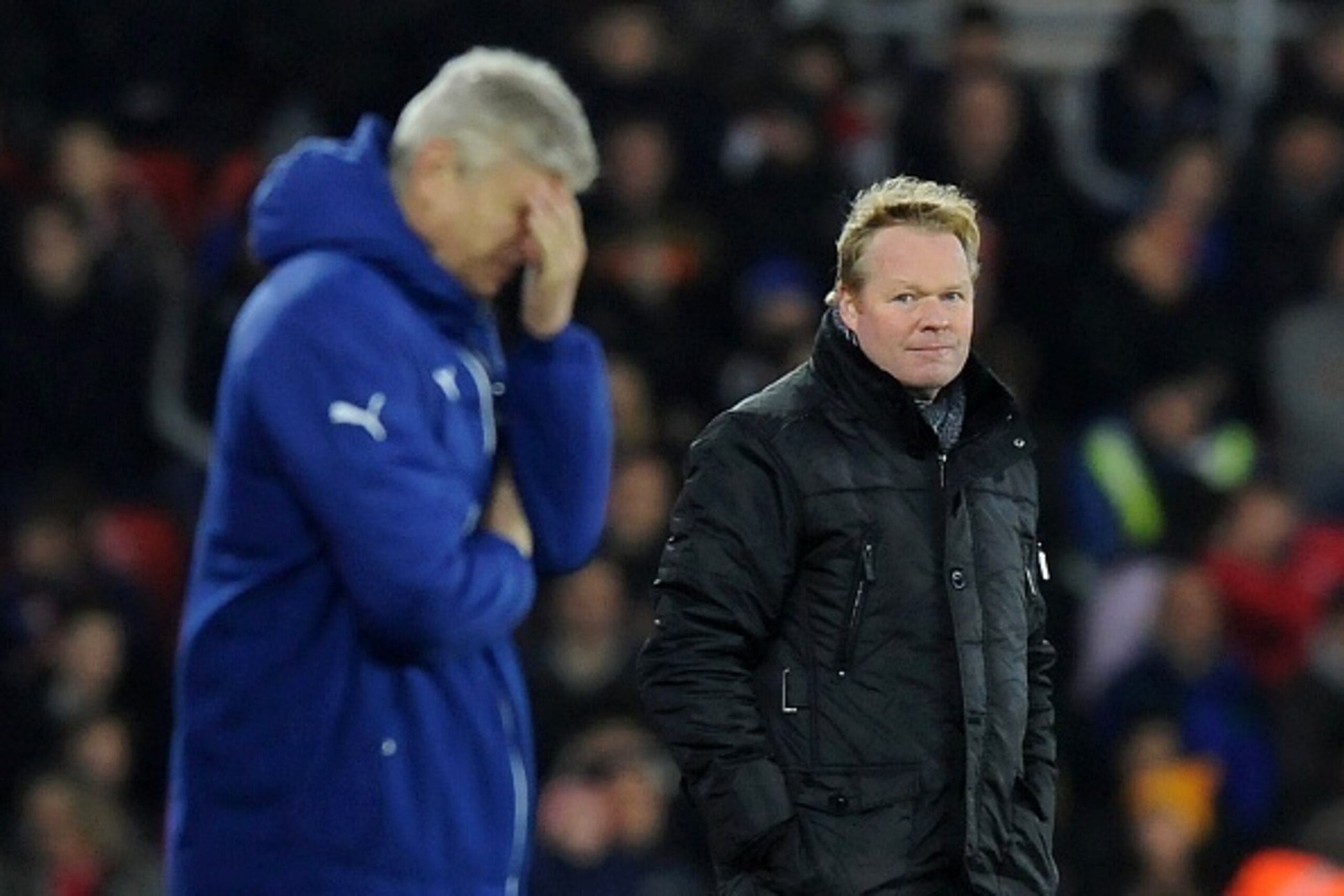 Southampton's Dutch manager Ronald Koeman (R) looks towards Arsenal's French manager Arsene Wenger during the English Premier League football match between Southampton and Arsenal at St Mary's Stadium in Southampton, southern England, on January 1, 2015. 