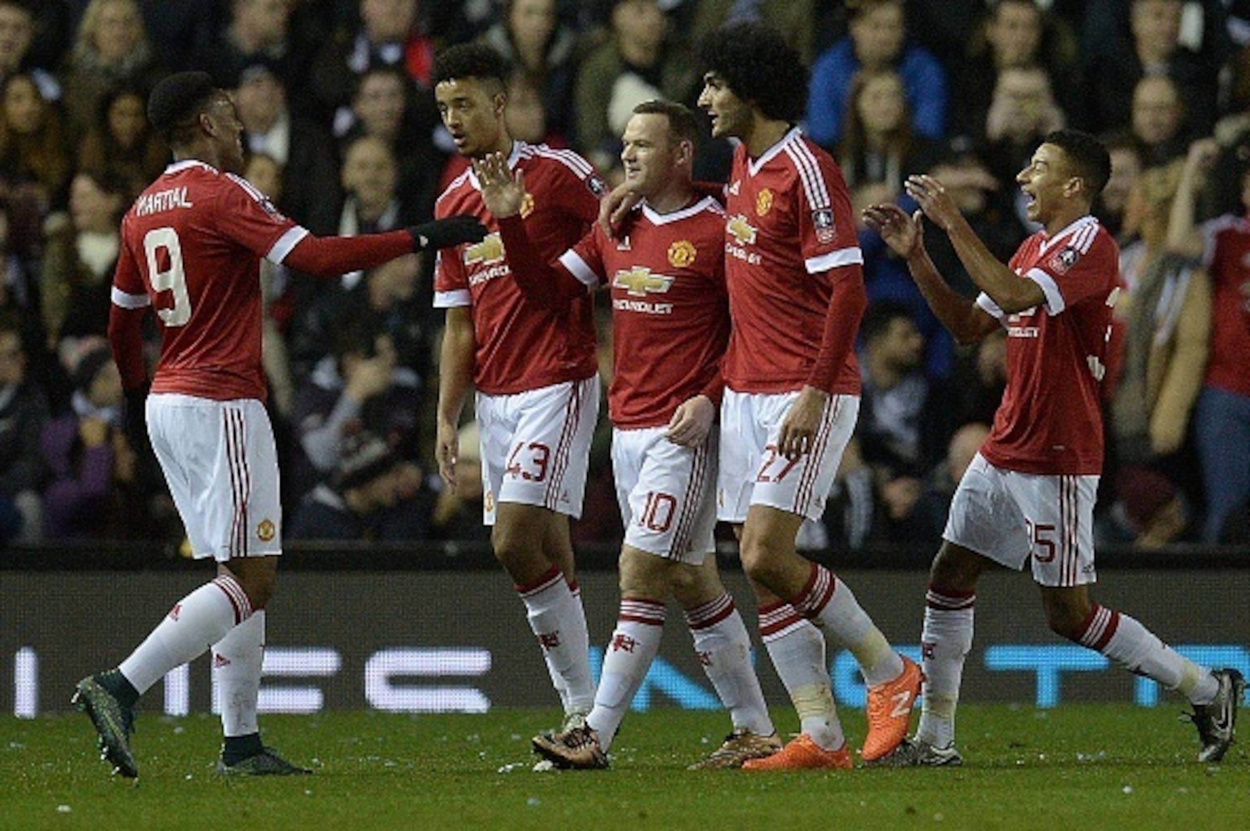 Manchester United's English striker Wayne Rooney (C) celebrates with teammates after scoring his team's first goal during the FA cup fourth round football match between Derby County and Manchester United at Pride Park stadium in Derby on January 29, 2016. Manchester United's English striker Wayne Rooney (C) celebrates with teammates after scoring his team's first goal during the FA cup fourth round football match between Derby County and Manchester United at Pride Park stadium in Derby on January 29, 2016.