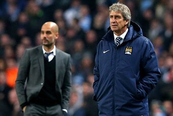 MANCHESTER, ENGLAND - NOVEMBER 25:  (R-L) Manuel Pellegrini the manager of Manchester City and Josep Guardiola the head coach of Bayern Muenchen look on during the UEFA Champions League Group E match between Manchester City and FC Bayern Muenchen at the E