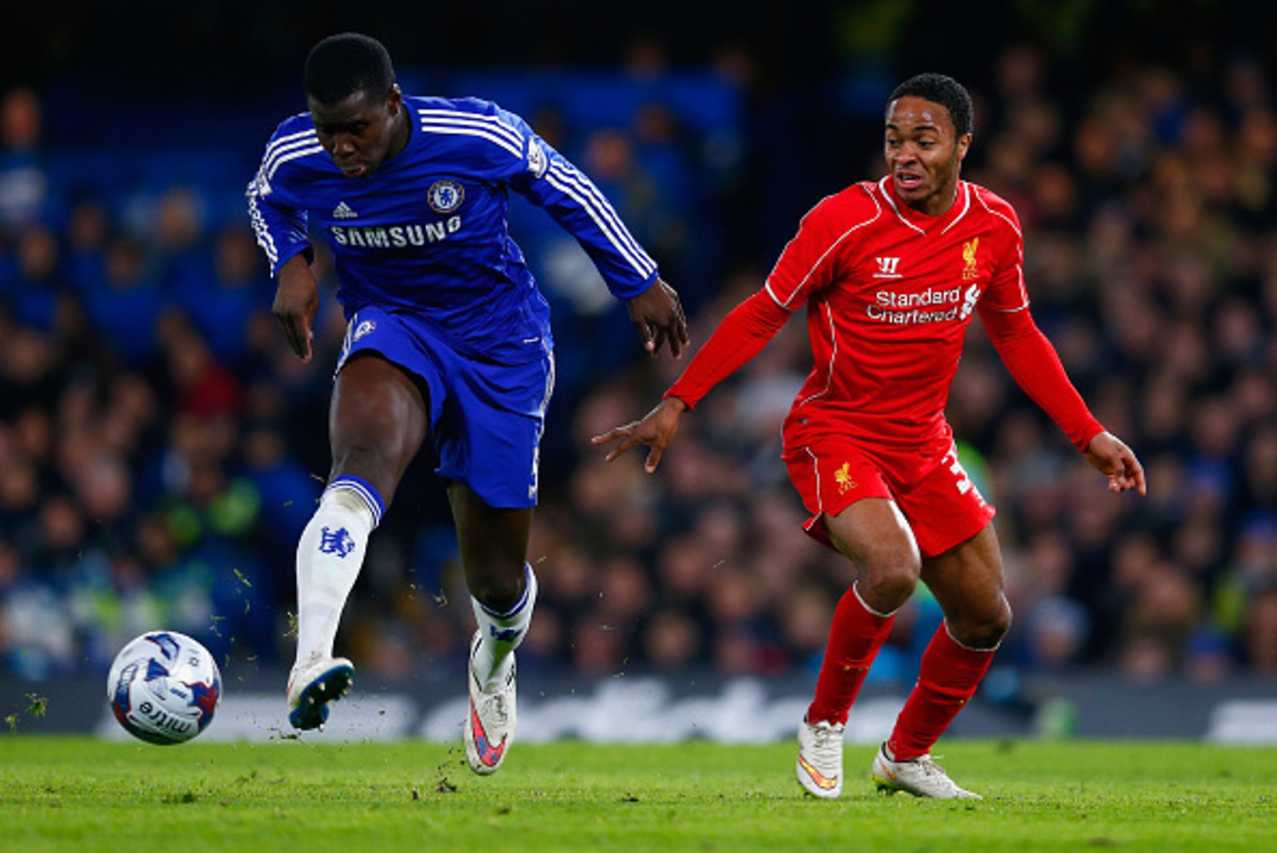 LONDON, ENGLAND - JANUARY 27: Kurt Zouma of Chelsea clears the danger from Raheem Sterling of Liverpool during the Capital One Cup Semi-Final second leg between Chelsea and Liverpool at Stamford Bridge on January 27, 2015 in London, England.  (Photo by Ju