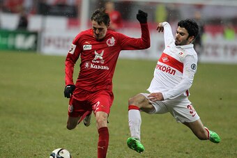 KAZAN, RUSSIA - NOVEMBER 30: Vladimir Dyadyun (L) of FC Rubin Kazan is challenged by Serdar Tasci of FC Spartak Moscow during the Russian Premier League match between FC Rubin Kazan and FC Spartak Moscow at the Kazan Arena Stadium on November 30, 2015 in 