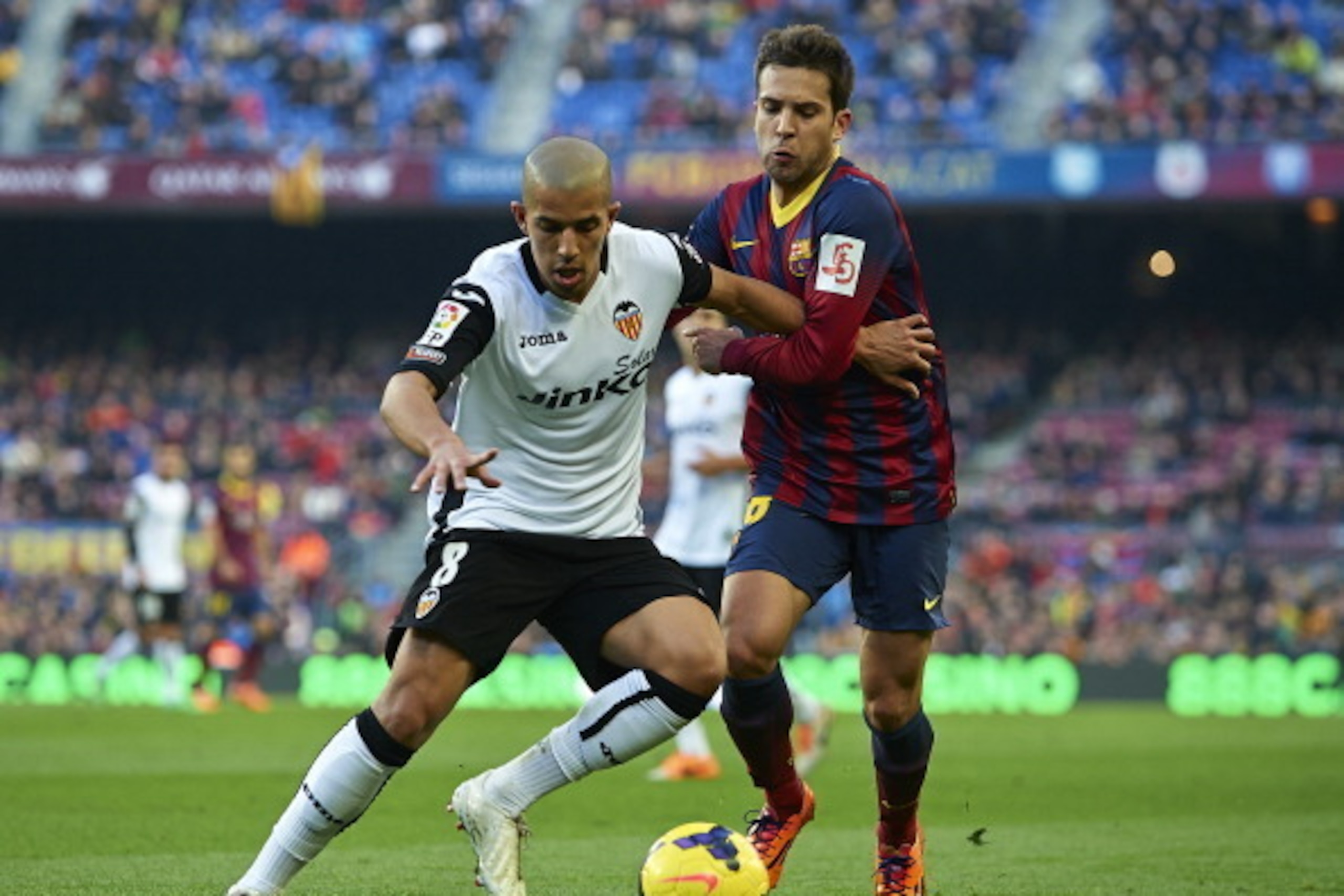 BARCELONA, SPAIN - FEBRUARY 01:   Jordi Alba (R) of FC Barcelona competes for the ball with Sofiane Feghouli of Valencia CF during the La Liga match between FC Barcelona and Valencia CF at Camp Nou on February 1, 2014 in Barcelona, Spain.  (Photo by Manue