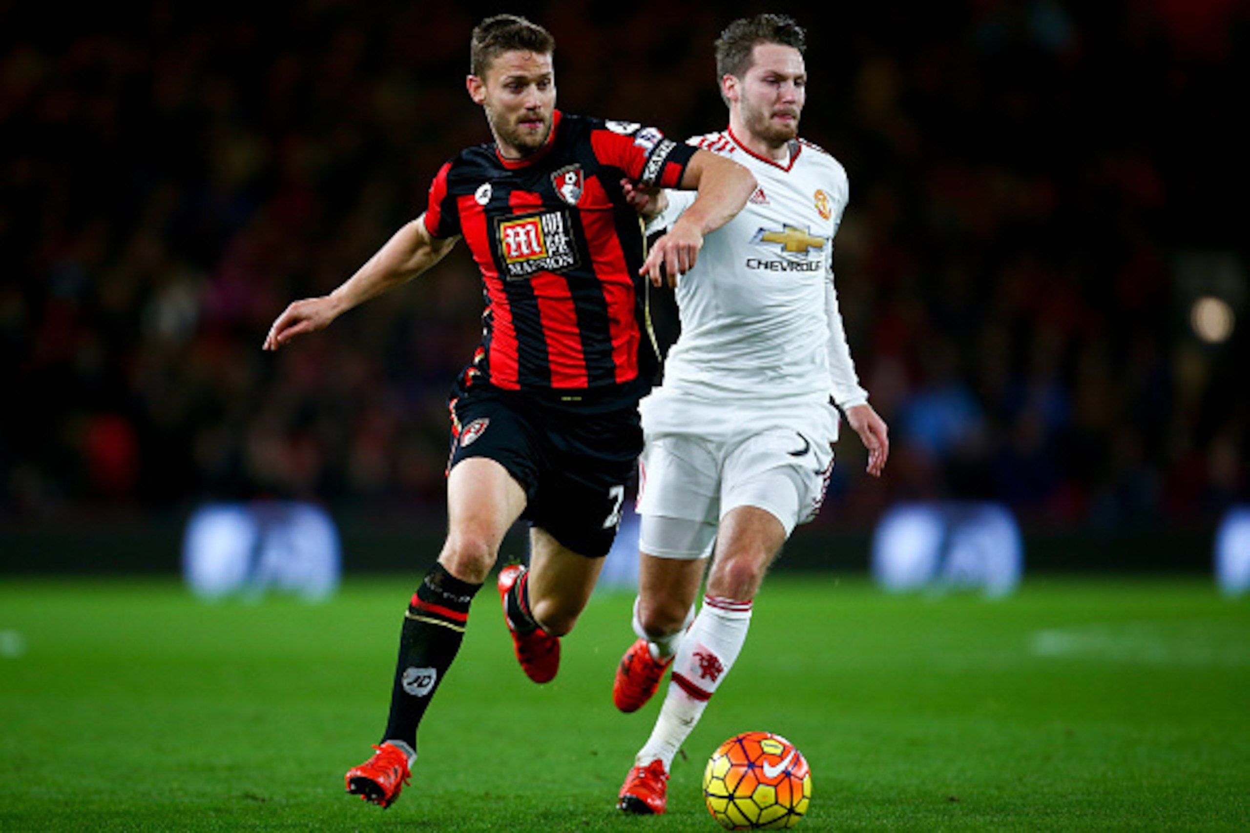 BOURNEMOUTH, ENGLAND - DECEMBER 12:  Simon Francis of Bournemouth and Nick Powell of Manchester United compete for the ball during the Barclays Premier League match between A.F.C. Bournemouth and Manchester United at Vitality Stadium on December 12, 2015 