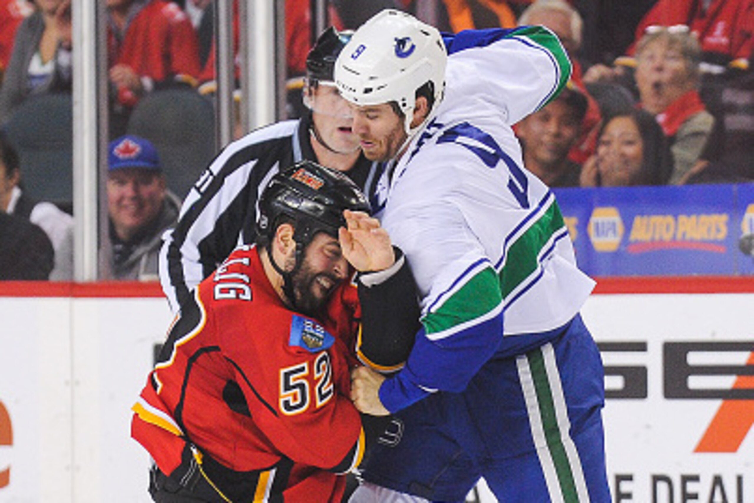 CALGARY, AB - OCTOBER 7: Brandon Bollig #52 of the Calgary Flames fights Brandon Prust #9  of the Vancouver Canucks in the NHL season opener at Scotiabank Saddledome on October 7, 2015 in Calgary, Alberta, Canada. (Photo by Derek Leung/Getty Images)