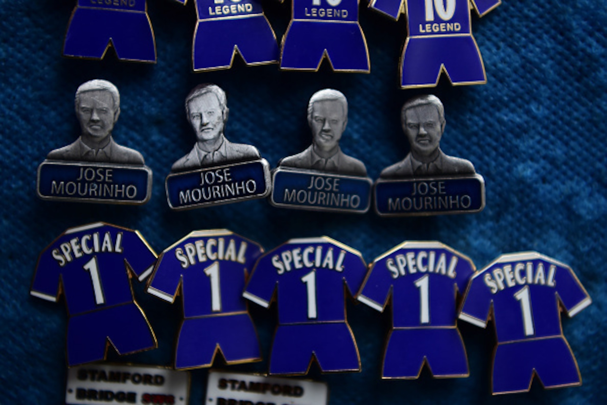 Badges featuring Chelsea's former Portuguese manager Jose Mourinho are on sale before the English Premier League football match between Chelsea and Sunderland at Stamford Bridge in London on December 19, 2015. Jose Mourinho attended the Championship match