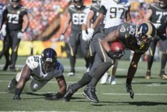 January 31, 2016; Honolulu, HI, USA; Team Irvin running back Todd Gurley of the Los Angeles Rams (30) scores a touchdown past Team Rice linebacker Elvis Dumervil of the Baltimore Ravens (58) during the second quarter of the 2016 Pro Bowl game at Aloha Sta