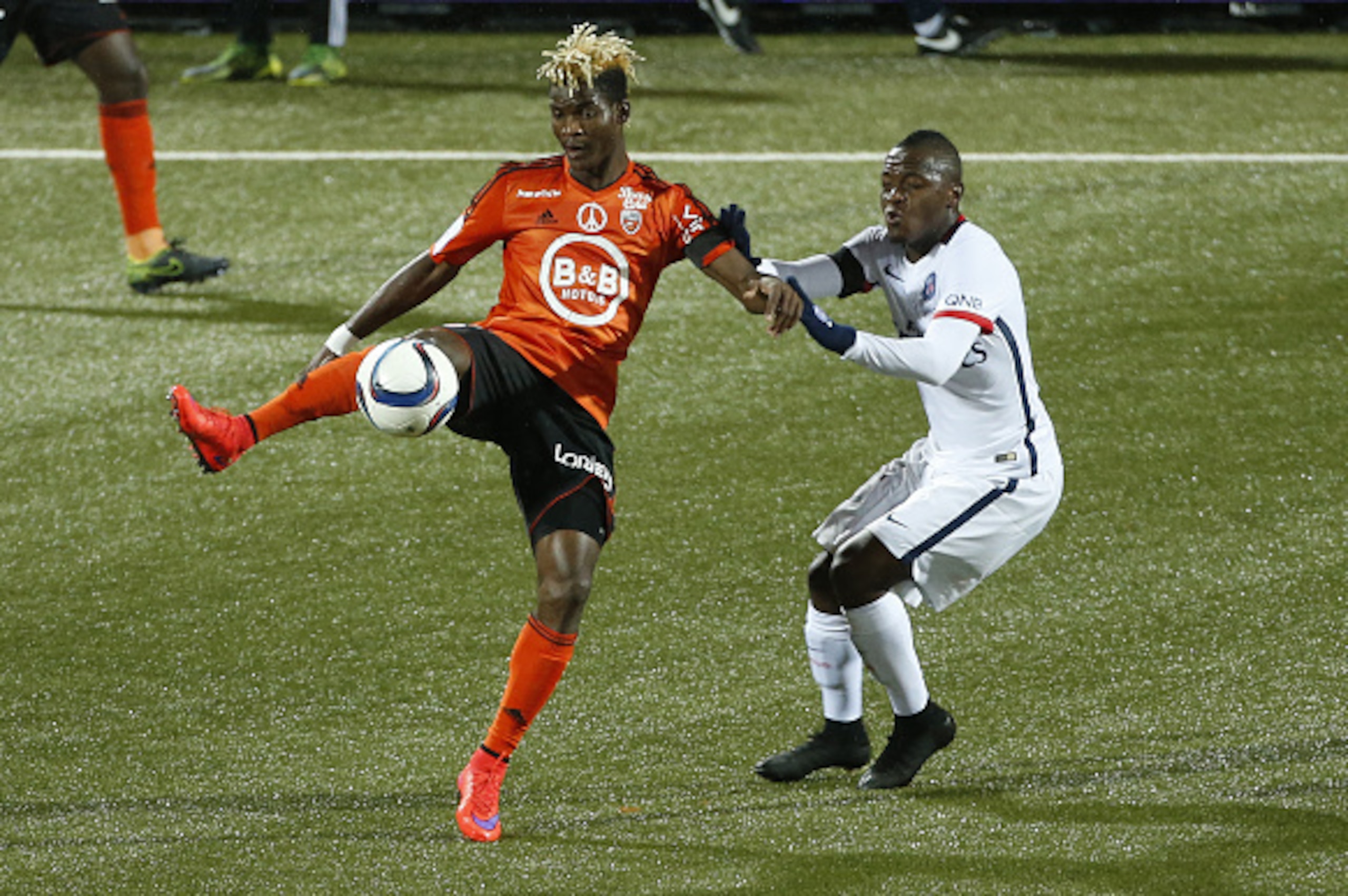 LORIENT, FRANCE - NOVEMBER 21: Didier Ibrahim Ndong of FC Lorient and Hervin Ongenda of PSG in action during the French Ligue 1 match between FC Lorient and Paris Saint-Germain (PSG) at Stade du Moustoir on November 21, 2015 in Lorient, France. (Photo by 